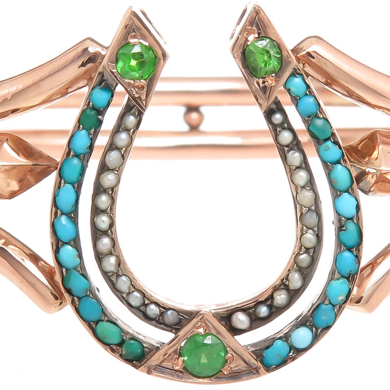 Circa 1910 14K rose gold Russian horse shoe bracelet, set with demantoid garnets, pearls and turquoise. Inside measurement = 7 inches.