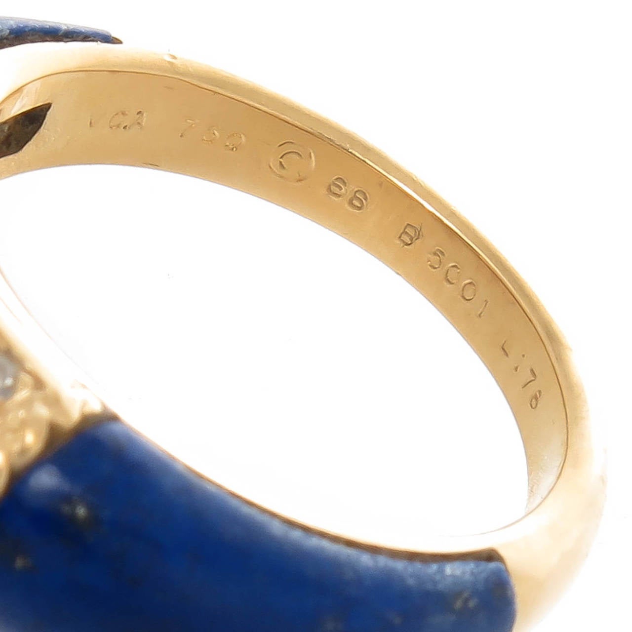 Circa 1990s Van Cleef and Arpels 18K yellow Gold Philippines Ring, set with Bright Blue Lapis Lazulli and Further set with Round Diamonds totaling 1/2 Carat. Signed, Numbered and Having French Hall Marks. Finger Size = 6 1/2