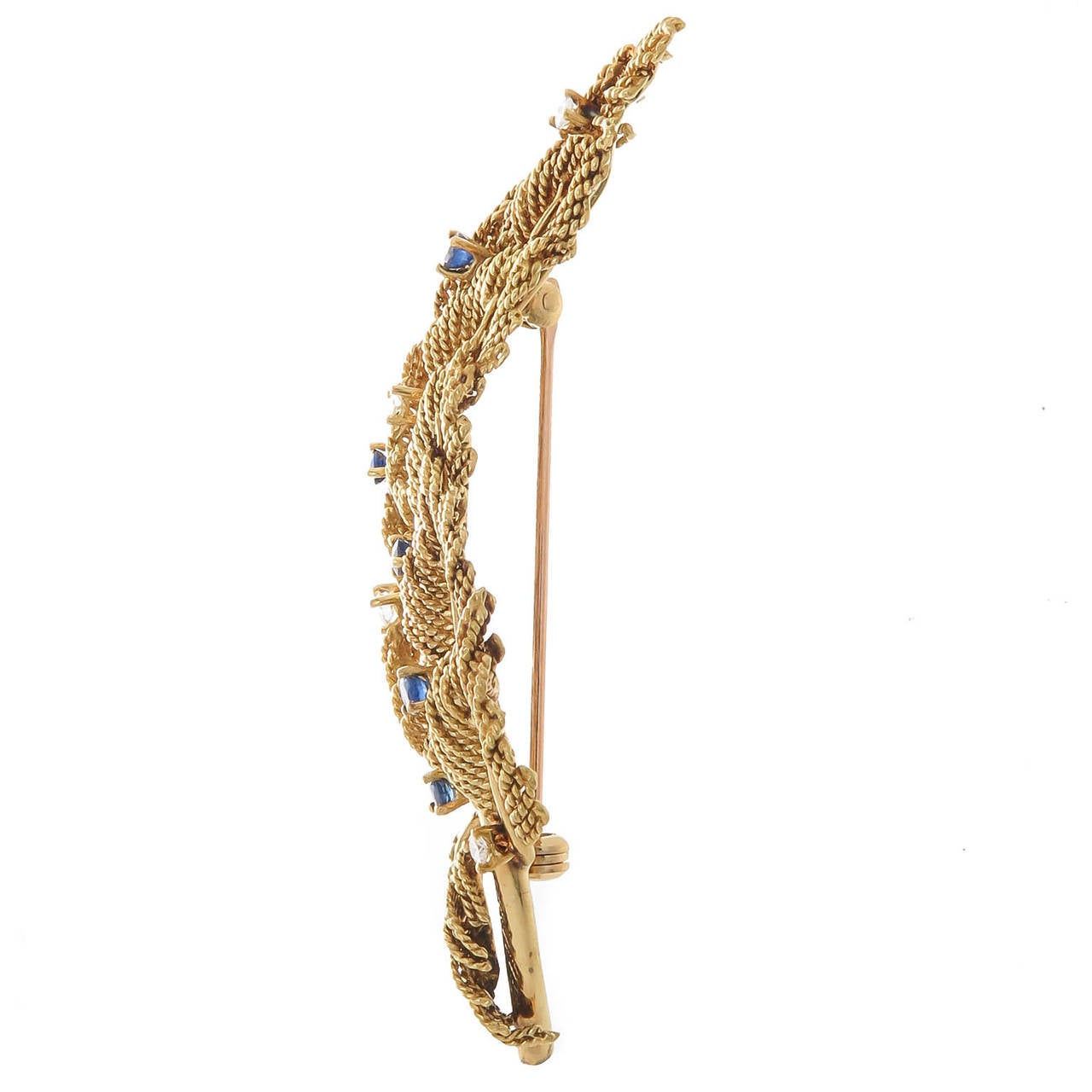 Circa 1970 Jean Schlumberger for Tiffany & Company 18K Yellow Gold Leaves brooch, detailed twisted rope leaves, accented with round Brilliant cut Diamonds and Sapphires. 3 inch total length. With original Tiffany Presentation Box.