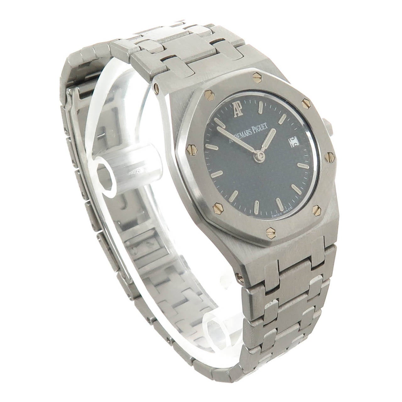 Circa 1980s Audemars Piguet Ladies Stainless Steel Royal Oak, Gray Waffle Dial with Raised Silver Markers and Calendar window at the 3 position, Quartz Movement. Steel Bracelet with deployment buckle. Original Audemars presentation box. Recently