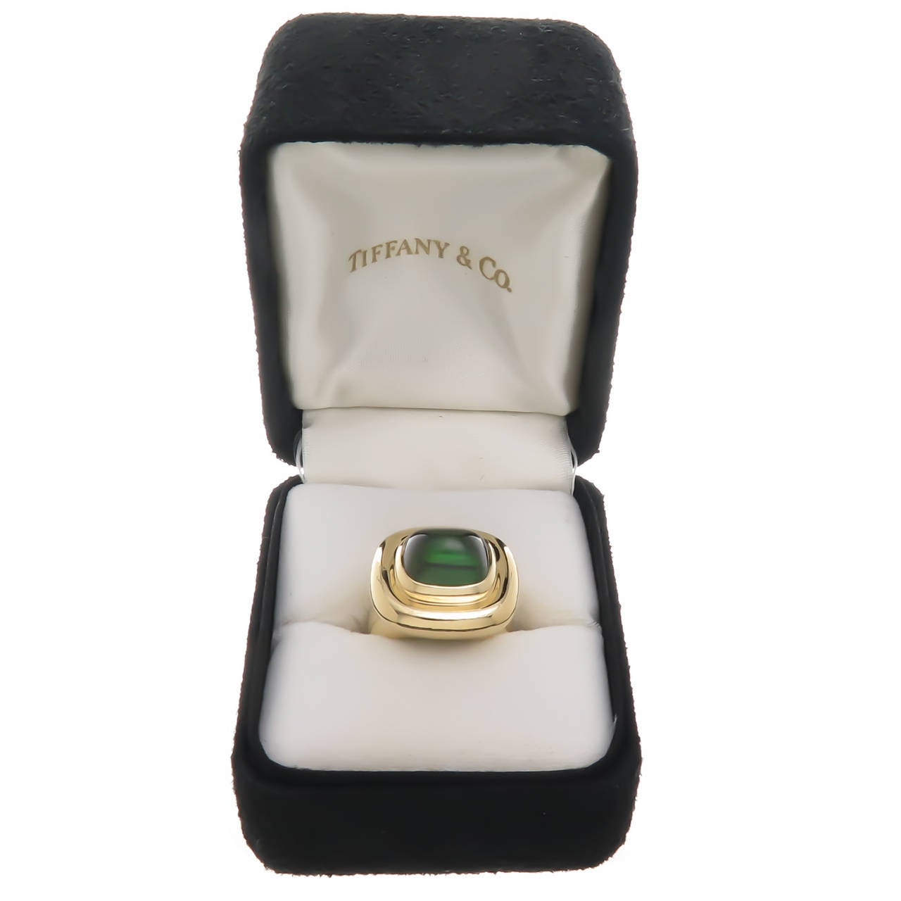 Circa 1990 18K yellow gold and cabochon tourmaline ring by Paloma Picasso for Tiffany & Co. Centrally set with a high dome cabochon deep rich green tourmaline of approximately 5 carats. Original Tiffany & Co. presentation box. Finger size = 6 1/2