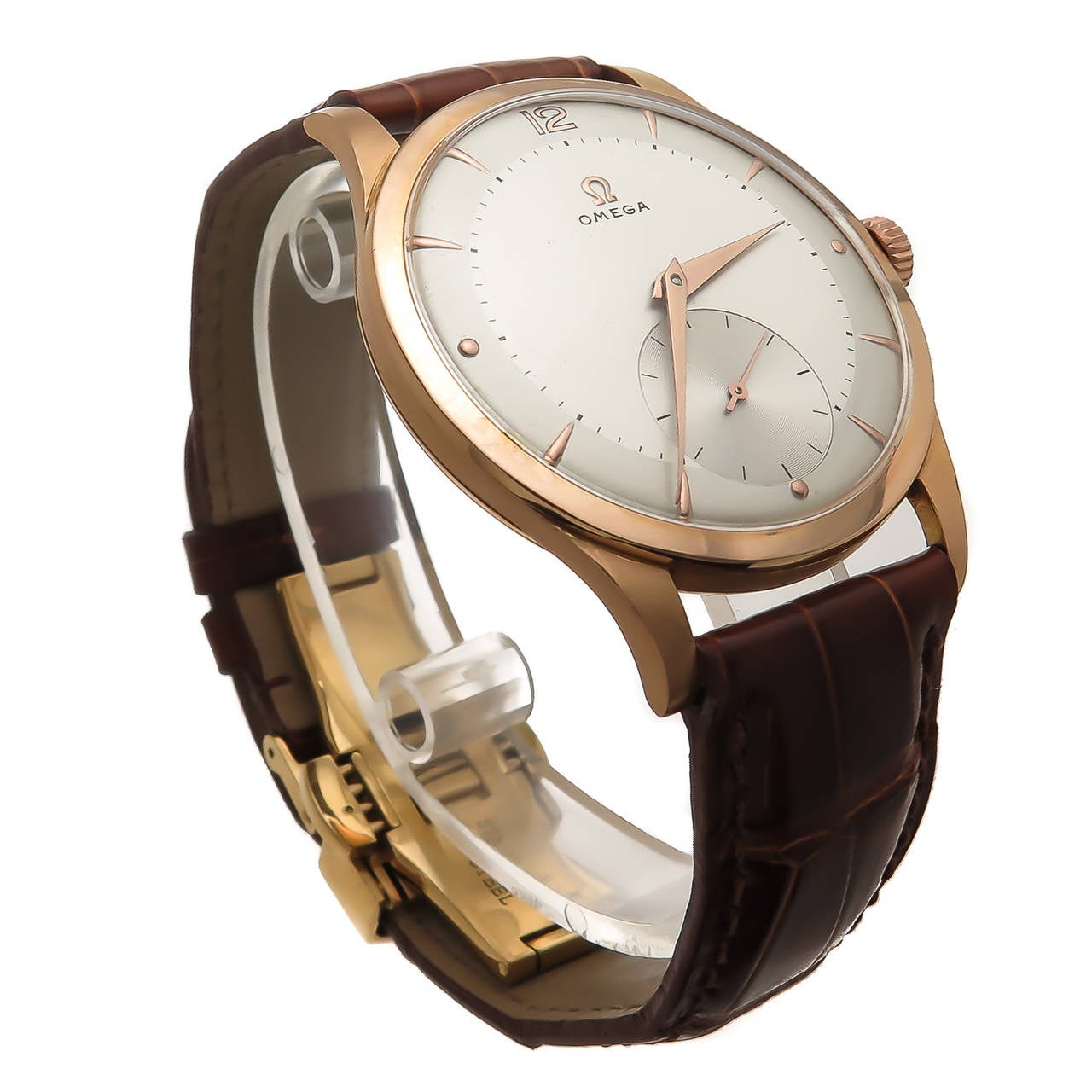 Circa 1940s Omega 18K Rose Gold Wrist Watch, 36 M.M. 3 Piece case, Manual wind 15 Jewel Caliber 265 Movement. Silvered Dial with Rose Gold markers and Hands. Brown Alligator Strap with Gold Plated Deployment clasp. This case is correct for the