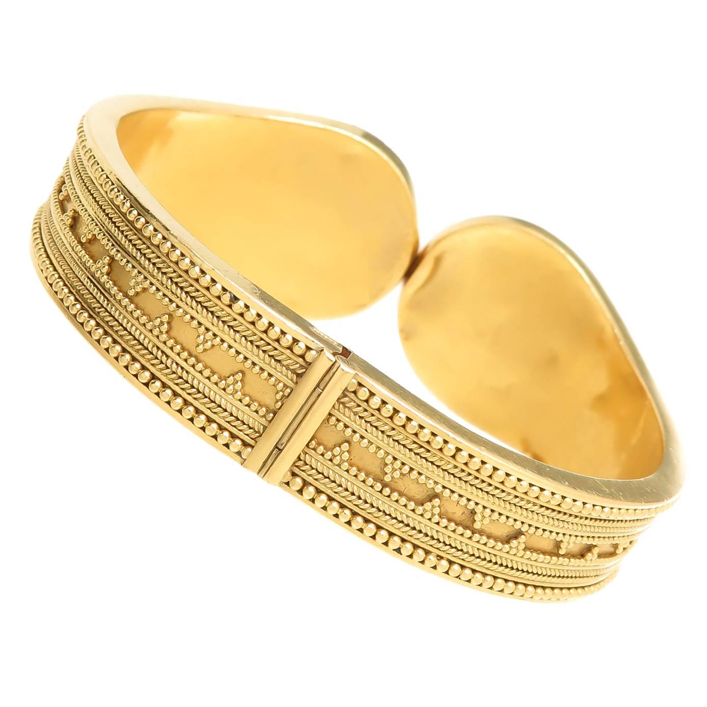 Circa 1990 Lalaounis 18K yellow Gold bangle-cuff bracelet in an ancient Greek motif with granulation accents that Lalaounis  is famous for. Having very good weight at 50 Grams and measuring 1 inch wide at the top center, inside measurement is 6 1/2