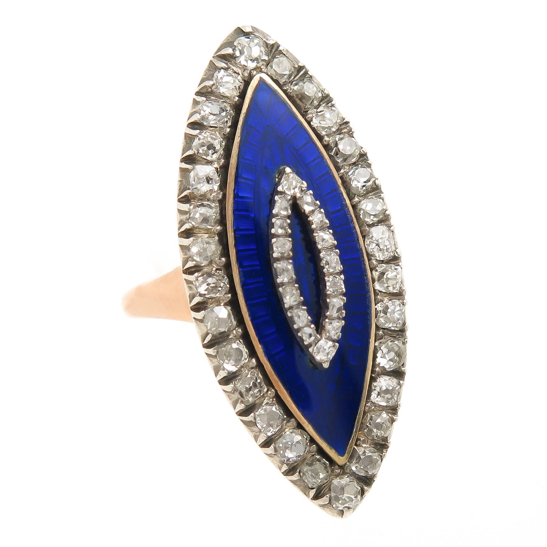 Circa 1870s Yellow  and Red Gold with silver top Navette shape ring measuring 1 1/4 inch long and 1/2 inch wide having a center of Cobalt Blue, Guilloche Enamel and set with Old Mine cut Diamonds totaling approximately 1 Carat. A very fine example