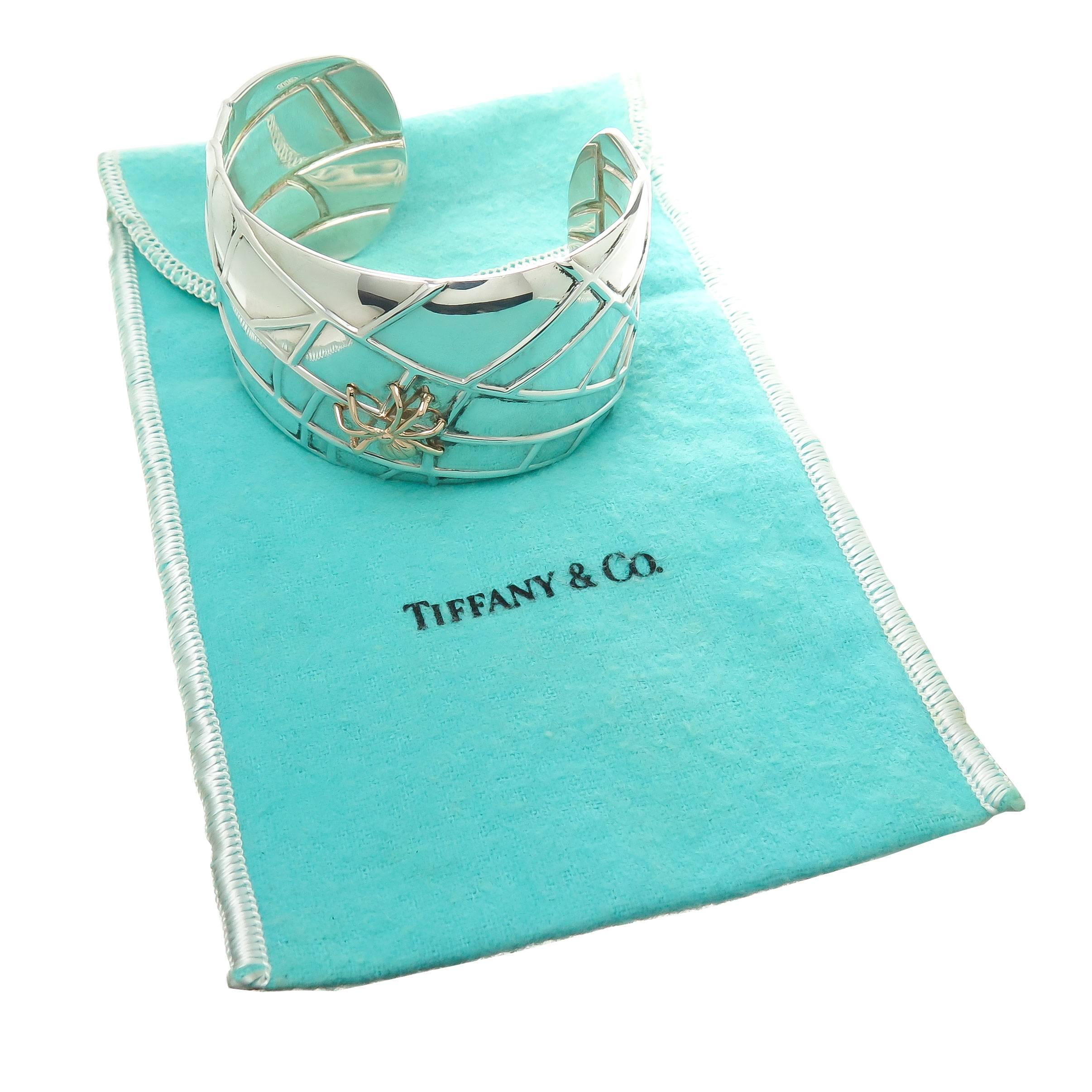 Circa 2001 Tiffany and Company Sterling silver and 18K yellow Gold Spider Web Cuff Bracelet. Measuring 1 1/2 inch wide and an opening of 1 1/8 inch and can be adjusted to fit most any wrist. Comes in original Tiffany pouch.