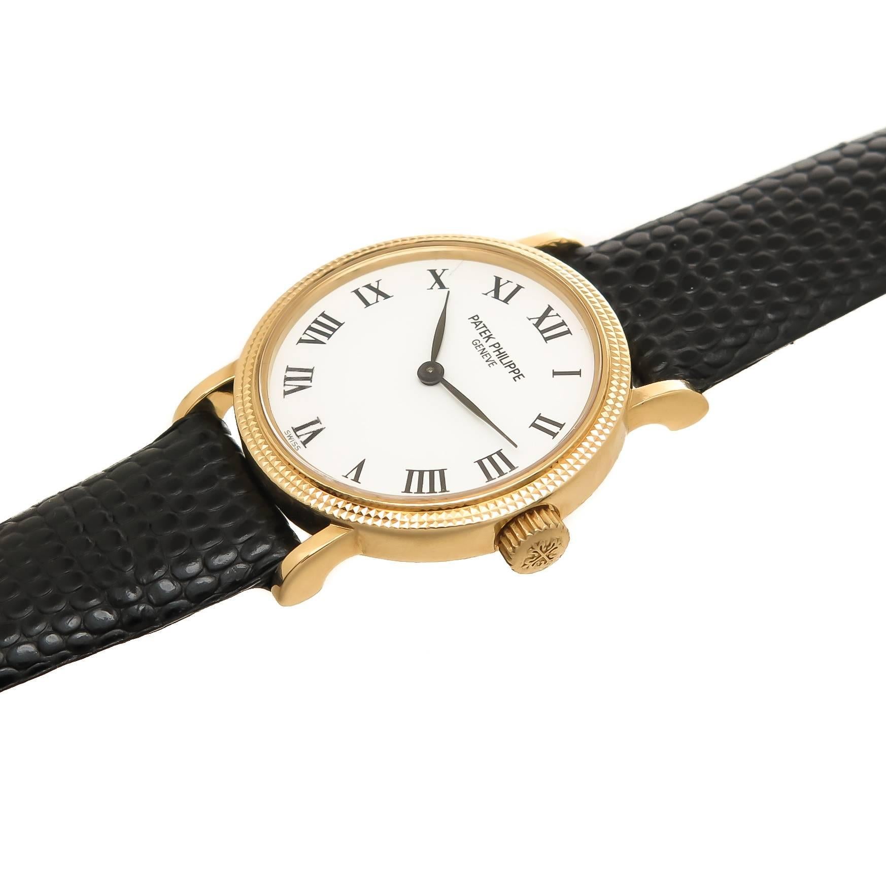 Circa 2000 Patek Philippe Reference 4819 18K Yellow Gold 25 MM Ladies Wrist Watch with Hobnail Bezel. Caliber E15 Quartz Movement, White Dial with Black Roman Numerals. New Black Lizard Strap. Comes in original Patek Philippe Box. An excellent