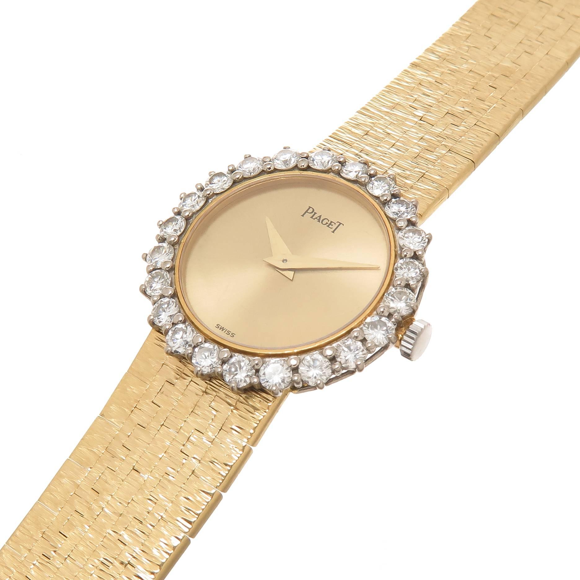 Circa 1970 Piaget 18K Yellow Gold Ladies Wrist Watch, measuring 23 MM in diameter and Having a Diamond set Bezel of Fine Round Brilliant cuts totaling 1 Carat. 17 jewel Manual wind Mechanical movement, Gold Dial and Hands. Attached to a 1/2 inch