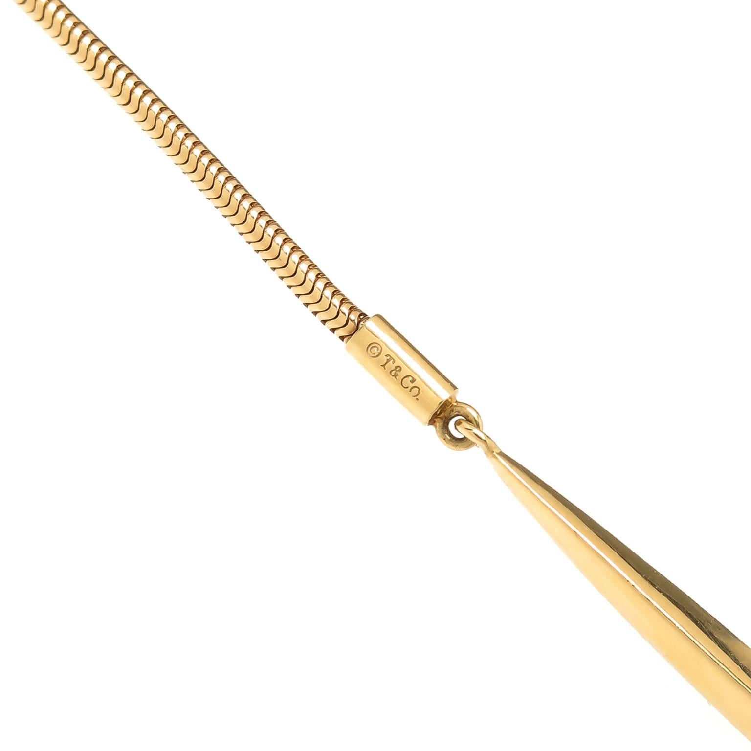 Circa 2000 Tiffany & Co. 18k yellow Gold Lariat Necklace, measuring 26 inch in length and made up of a very soft 1.6 MM thick snake style chain with suspended solid spear shape bottoms. 