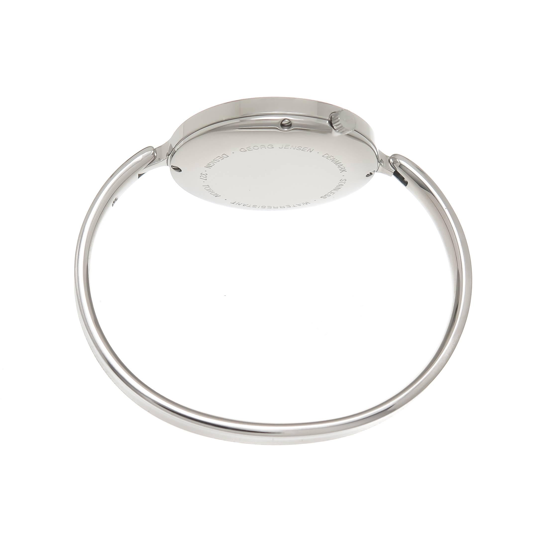 Circa 1990 Georg Jensen Vivianna Bangle Watch By Torun. 1 1/4 inch Diameter watch attached to a 3/16 inch wide bangle bracelet with a 6 inch inside measurement. Quartz Movement, silver mirrored Dial. Recently serviced and comes with a one year N.