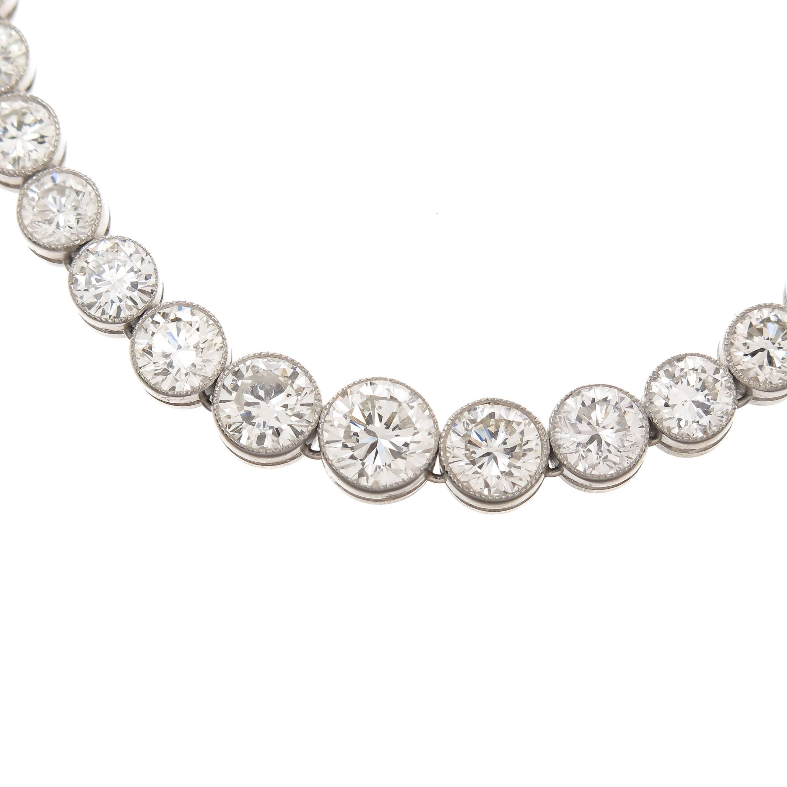Circa 2010 Platinum Riviere Necklace set with 11. 24 Carats of Old Mine, European and ingle cut Diamonds, Bezel settings with a Millegrain edge, the diamonds graduate in size from .05 Carat to the largest stone of 3/4 Carat. The Diamonds all grade