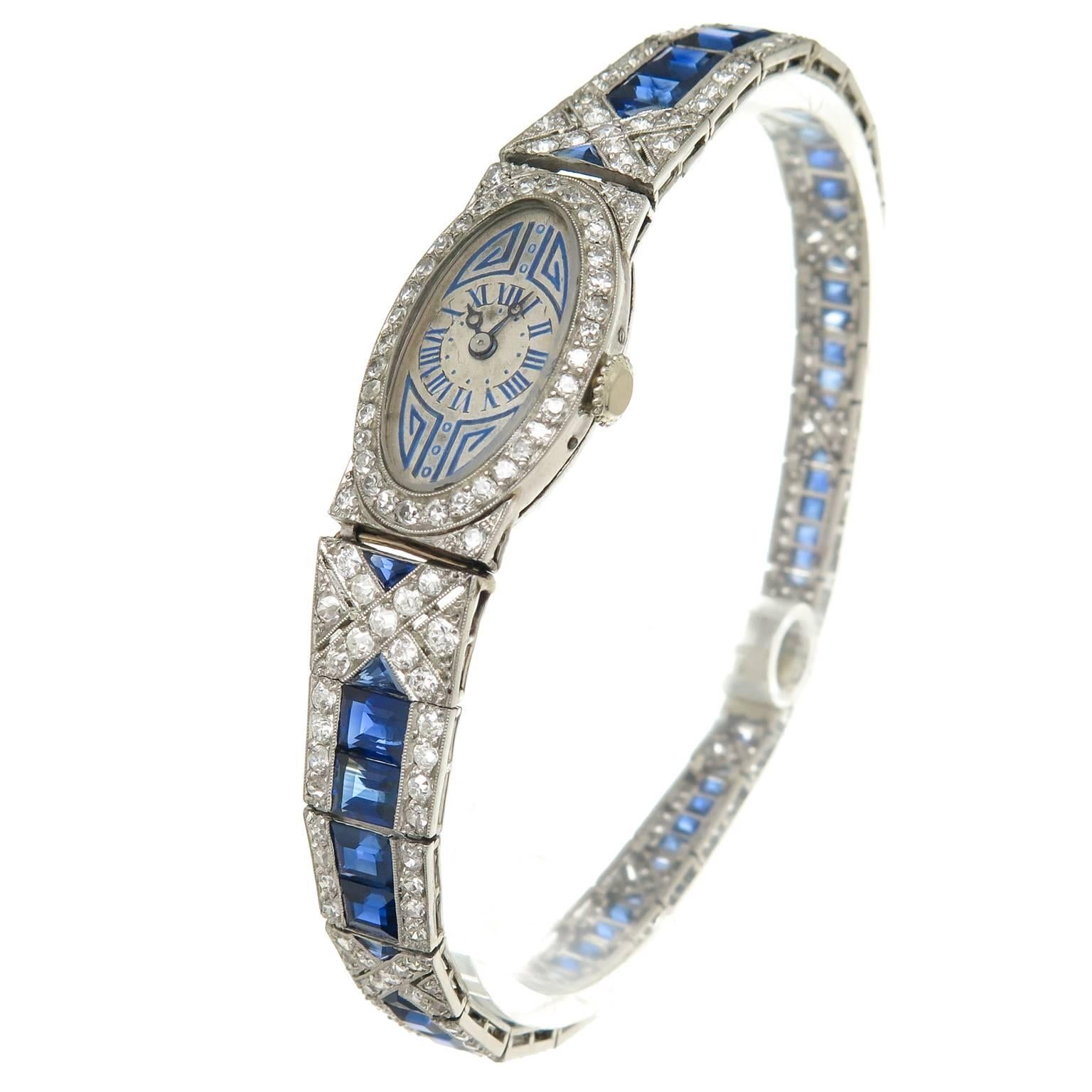 Circa 1930 Platinum Bracelet Watch, set with European cut Diamonds totaling approximately 3 Carats and further set with Natural, very fine Color Triangle and square cut Sapphires totaling approximately 4 Carats. The watch measures 7 3/8 inch in