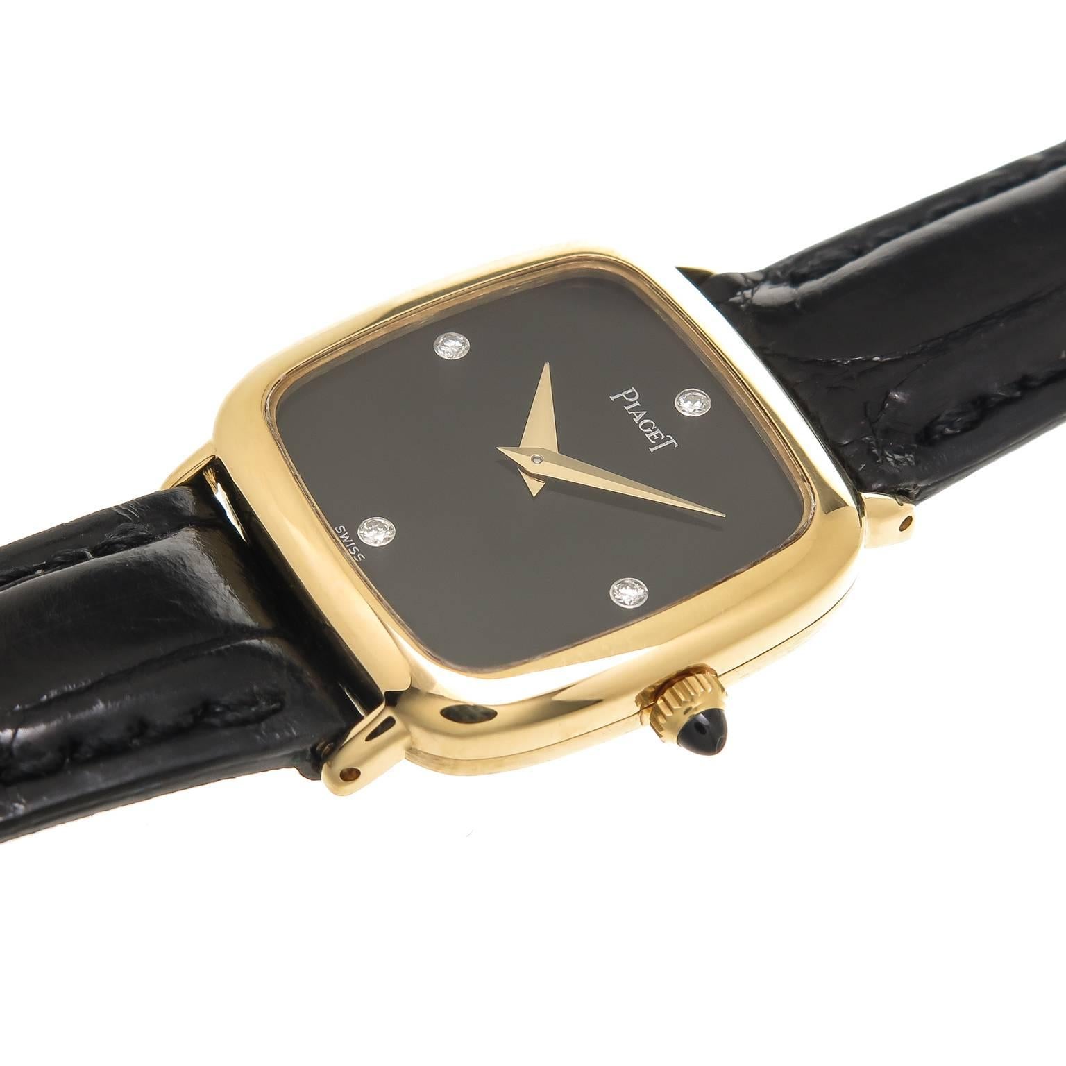 Circa 1980 Piaget 18K yellow Gold Ladies Watch, Cushion Water resistant  Case measuring 27  X  23 MM and 5 MM thick. Mechanical, Manual Wind Movement, Black Onyx Dial with Diamond Markers and a stone set Crown. New Piaget Black Padded Strap with 18K