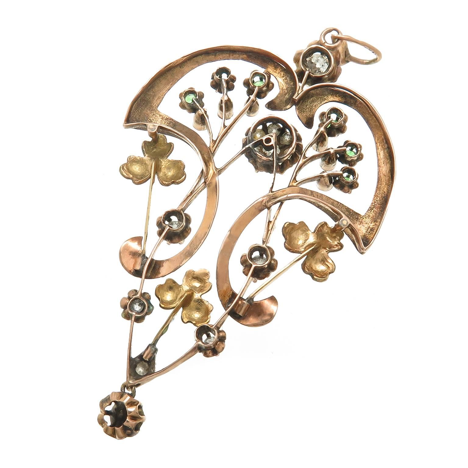 Circa 1910 14K Yellow Gold Russian pendant set with Old Mine Cut Diamonds, Green Demantoid Garnets and further decorated with Enamel Flowers. Measuring 2 3/4 inch in length and 1 5/8 inch wide. Having City stamps for Moscow and also having partially