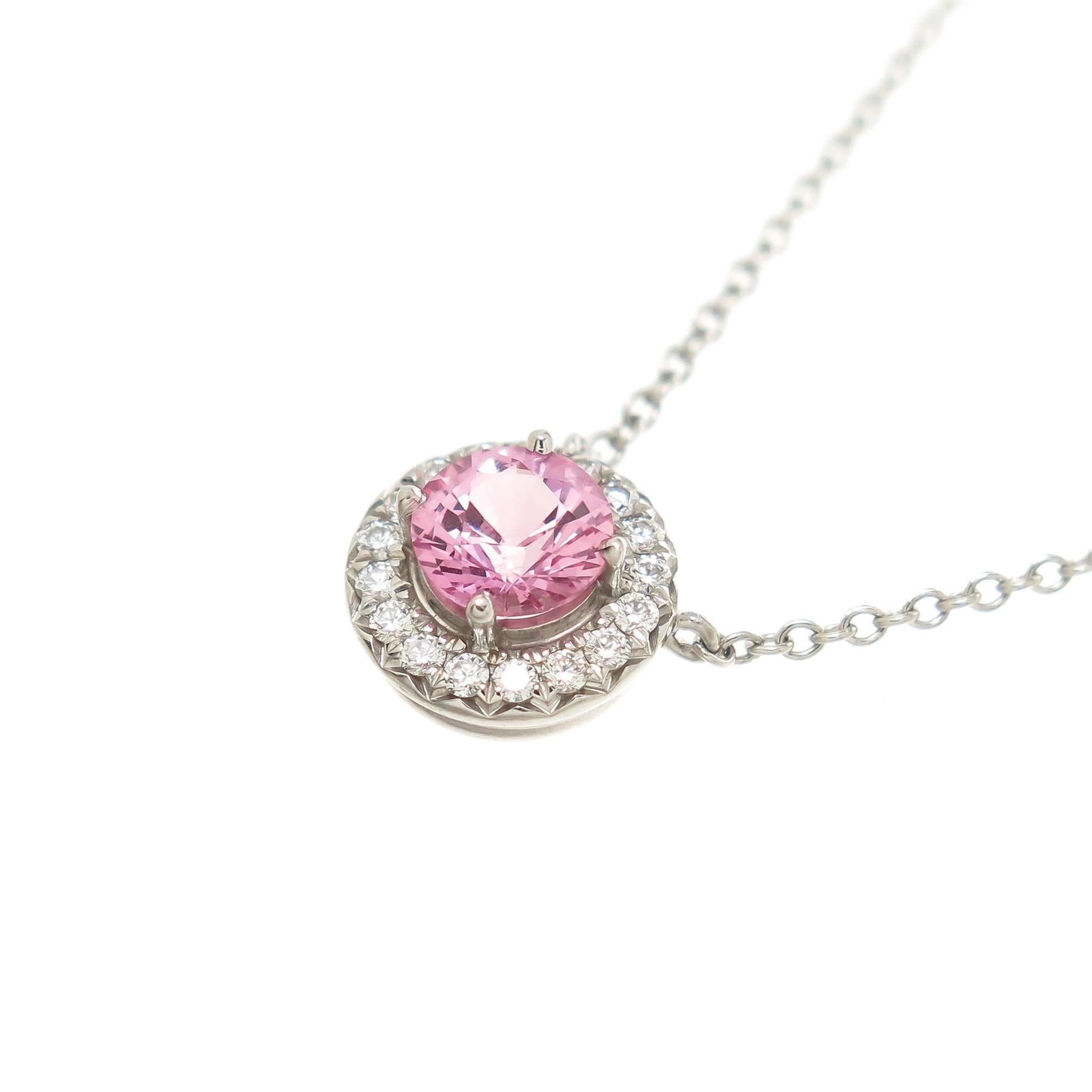Circa 2012 Tiffany & Company Soleste Collection Platinum Pendant, set with a Very fine color .40 carat Pink Sapphire and surrounded by Round Brilliant cut Diamonds totaling .09 Ct. Suspended from a 16 inch Platinum chain. Comes in the original