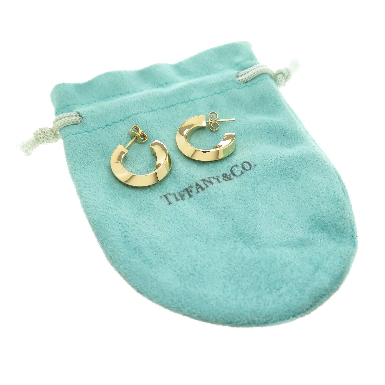 Circa 2000 Tiffany & Company 18K yellow Gold Hoop Earrings, of solid construction in a slight twist design, measuring 3/16 inch wide and 3/4 inch in diameter. Comes with a Tiffany Gift pouch.