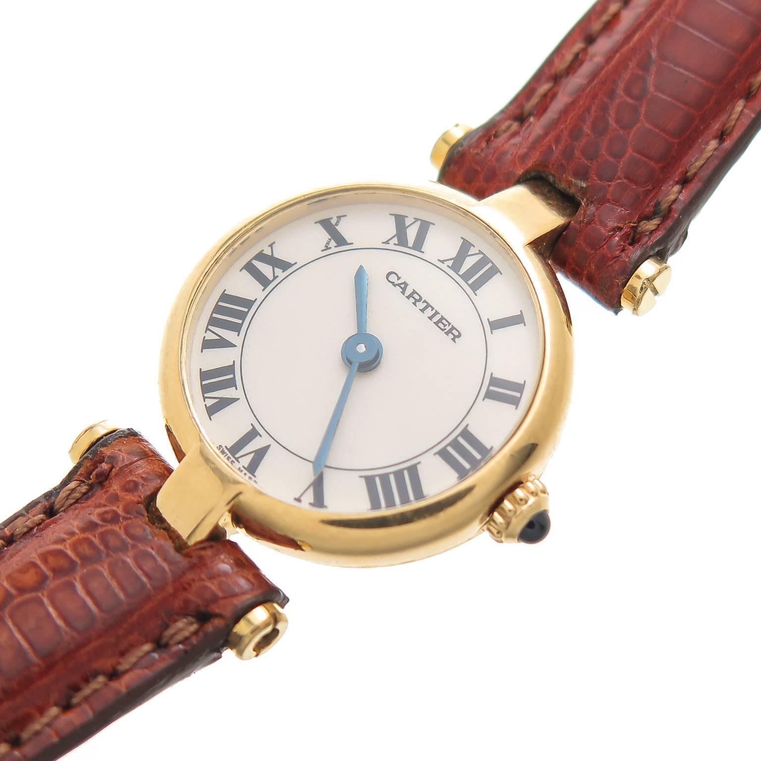 Circa 1990 Cartier Vendome Mini, 18K Yellow Gold 19 MM Diameter case, Quartz Movement, White Dial with Black roman Numerals, sapphire Crown. New Hadley Roma, brown Padded Lizard Strap, original Cartier Gold plated Tang Buckle. Cartier Red Suede