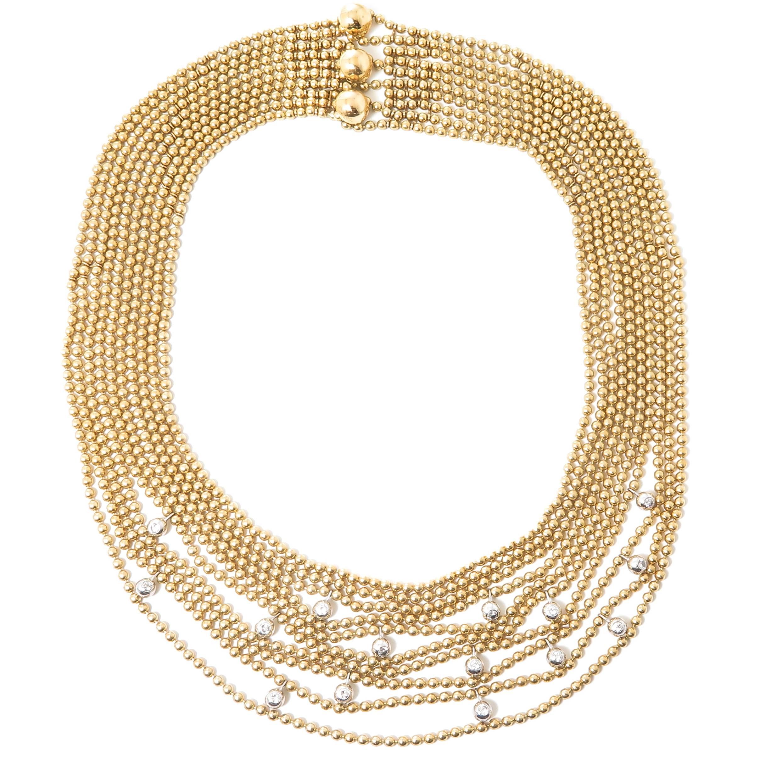 Circa 2000 Cartier 18K Yellow and White Gold Draperie De Decolette Necklace, 10 Strands of 2 MM Round Gold Beads and 15 random set White Gold 4 MM beads each set with a Round brilliant cut Diamond, Diamond total approximately 1 Carat. Neck Length