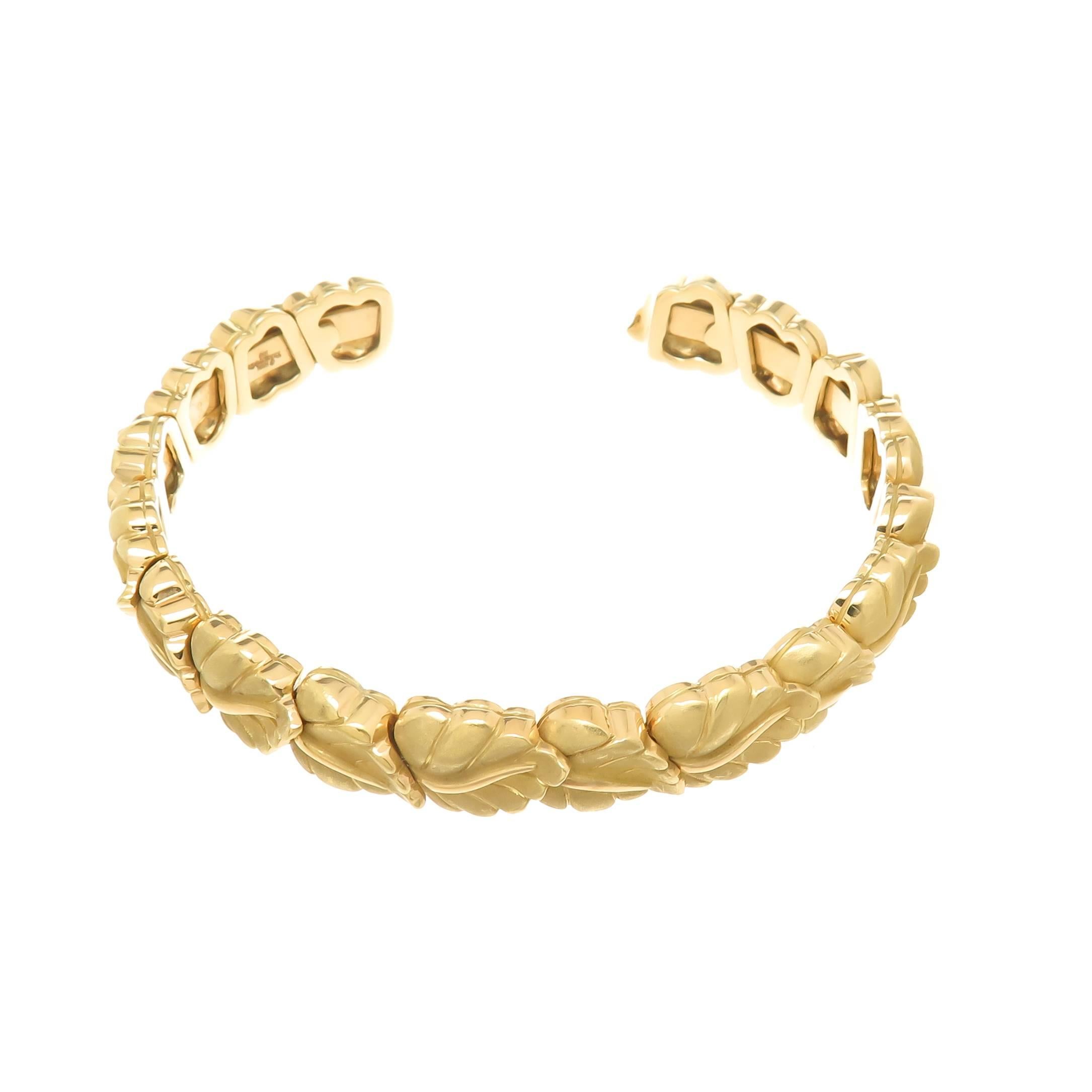 Circa 2002 Tiffany & Company 18K Yellow Gold Leaf Bracelet, measuring 3/8 inch wide and having an opening of 1 inch, this bracelet is flexible with each section attached separately to give it movement and so it can fit most any wrist. The leaves are