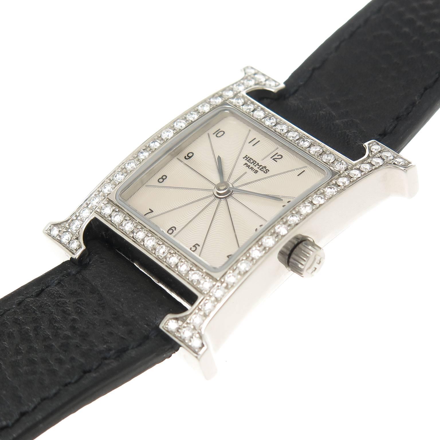 Circa 2010 Hermes "H" Hour Ladies Wrist watch, 30 X 21 MM stainless steel case, Quartz Movement, Silvered Engine turned Guilloche Dial with Raised Markers. Factory Diamond set Bezel of Round Brilliant cut Diamonds totaling 1.20 Carat.