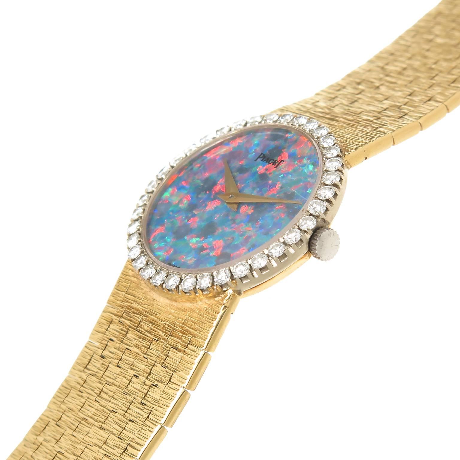 Circa 1970s Piaget, 18K Yellow Gold case measuring 29 MM and having a Factory Diamond set bezel containing 36 Round Brilliant cut Diamonds totaling 
1.10 Carat. Black Opal Dial, gold hands, mechanical, manual winding 17 Jewel movement. 5/8 inch