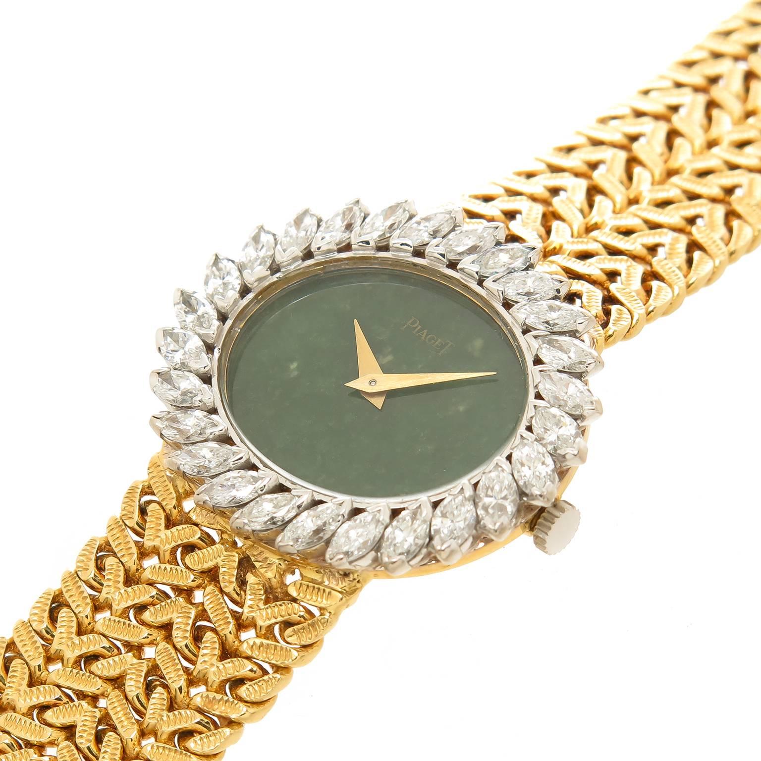 Circa 1970s Piaget 18K Yellow Gold Ladies Wrist watch, measuring 29 X 24 MM oval and having a White Gold Bezel set with Marquise Diamonds totaling 2.50 Carats and Grading as G in Color and VS in Clarity. Manual Wind Movement, Green Agate stone Dial