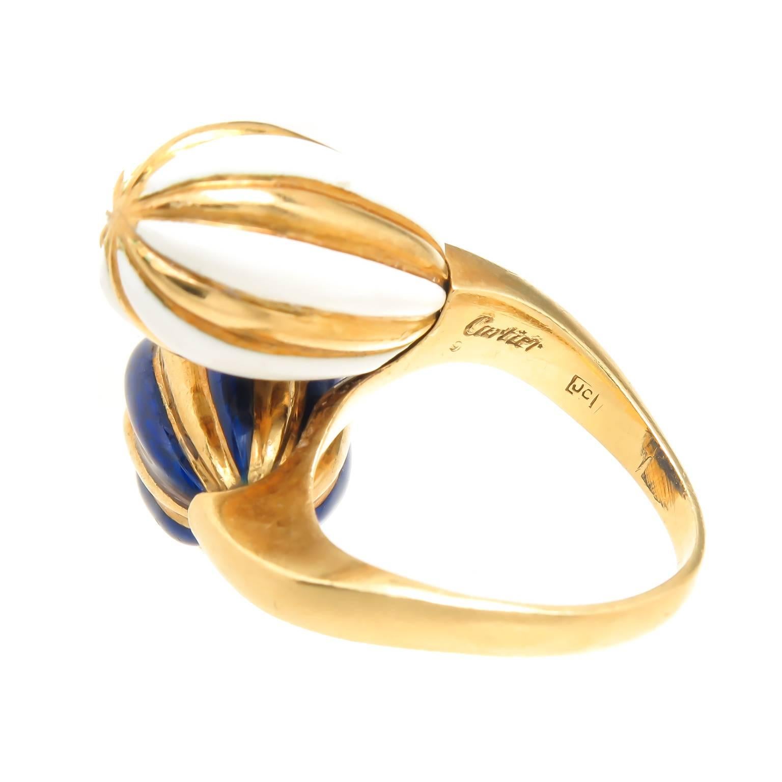 Circa 1980 Cartier 18K Yellow Gold and Enamel Ring, owned and worn by Dame Joan Collins,  having two oval bulb form elements in a by pass design, measuring 1 inch across the top. Signed and numbered and having British stamps from the London Cartier