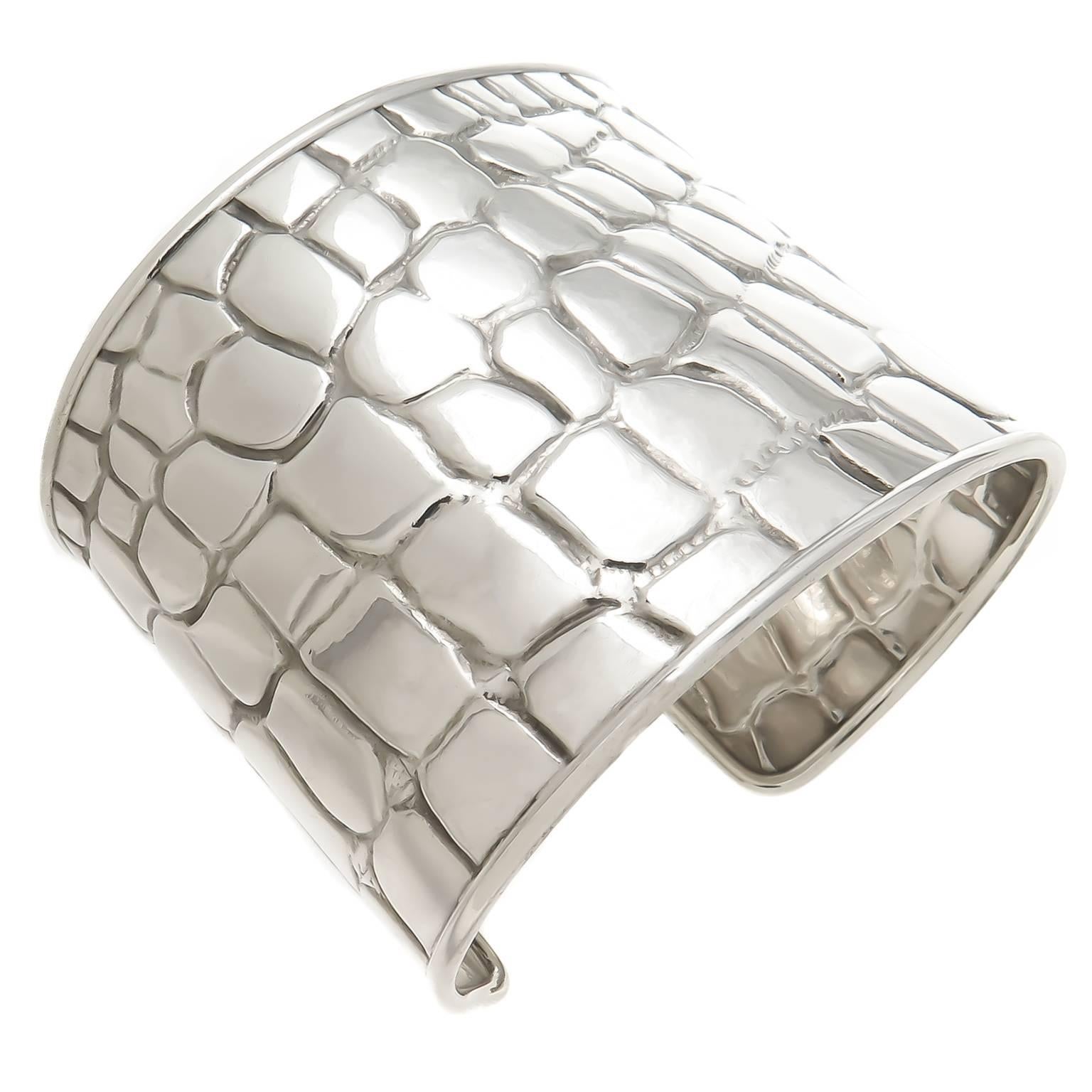 Circa 2000 Tiffany & Company Sterling Silver wide Cuff bracelet with a Crocodile textured pattern. Measuring 2 inch wide and having a wrist opening of 1 1/4 inch that can be adjusted to fit most any wrist. Comes in original Tiffany Gift box.