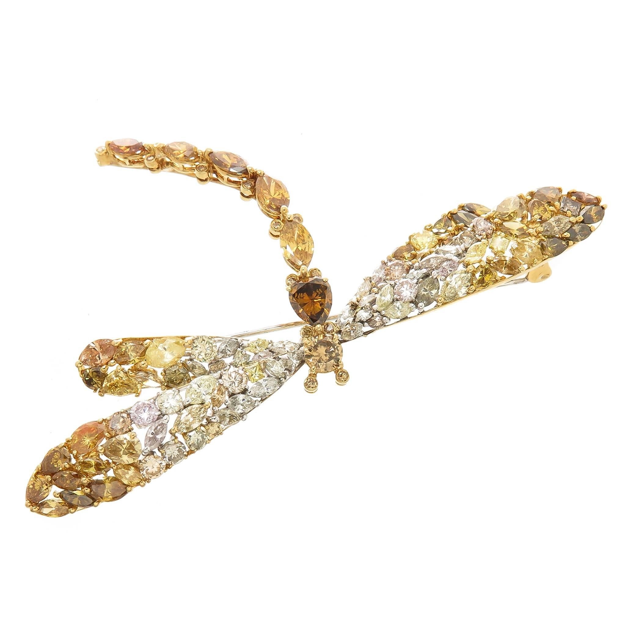 Circa 1990s Dragon Fly brooch set with 10 Carats of Natural Fancy Color Diamonds of Round, Pear and Marquise Shapes and being, Cognac, Yellow, Orange, Green and Light Pink in color. The brooch measures 3 1/8 inch wing tip to tip.  