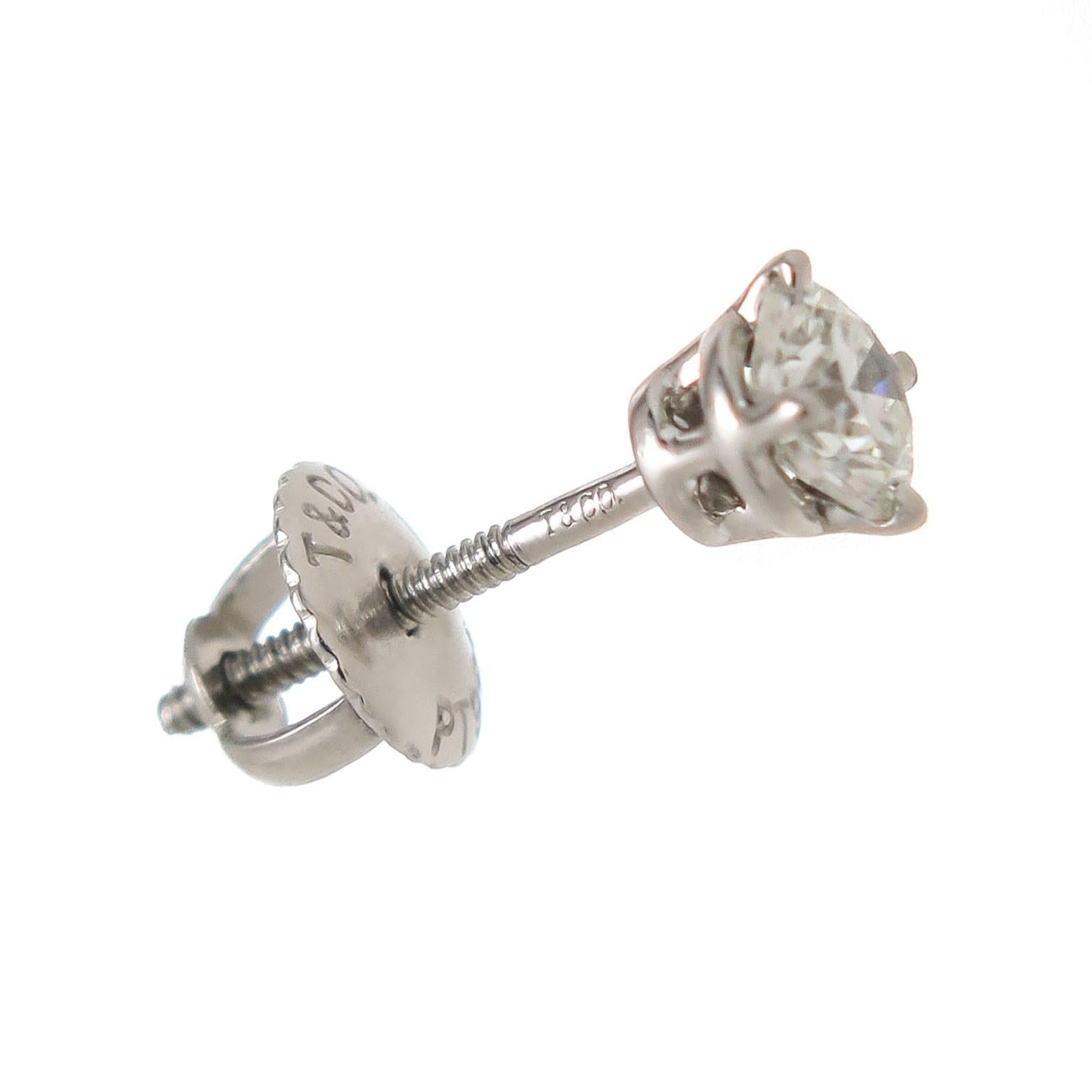 Circa 2010 Tiffany & Company Platinum Diamond stud Earrings, set with 1/4 carat Round brilliant cut Diamonds for a total of 1/2 carat for the earring pair. Each stone grades as G in Color and VS in Clarity. Having screw backs and come in the
