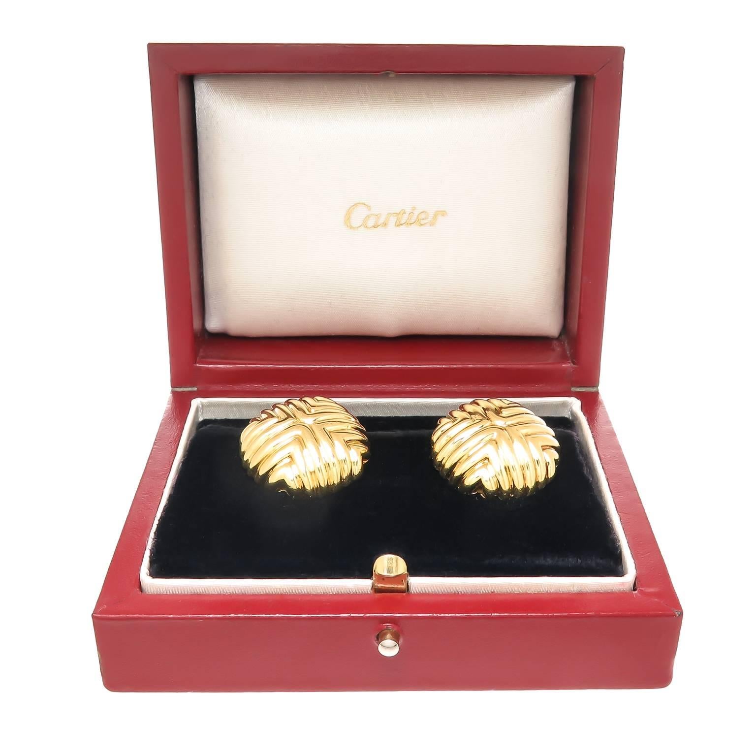 Circa 1980 Cartier 18K Yellow Gold Button Form Earrings, measuring 7/8 inch in diameter and 3/16 inch thick.Having an omega clip back to which a post can be easily added if desired. Signed, Numbered and in the original Cartier Presentation box.