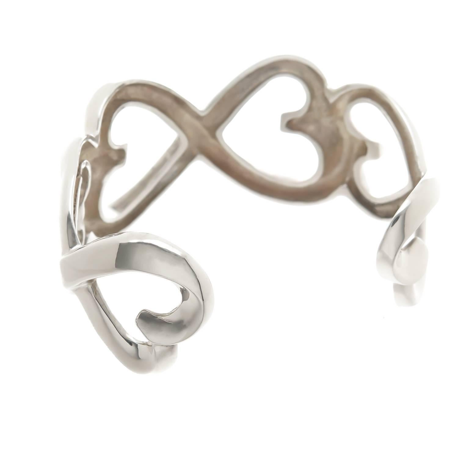 Circa 1990s Paloma Picasso for Tiffany & Company Sterling Silver Open Hearts Cuff Bracelet, measuring 1 1/4 inch wide with a wrist opening that measures 1 1/4 inch. Excellent, almost unworn condition and and comes in the original Tiffany Suede Pouch.