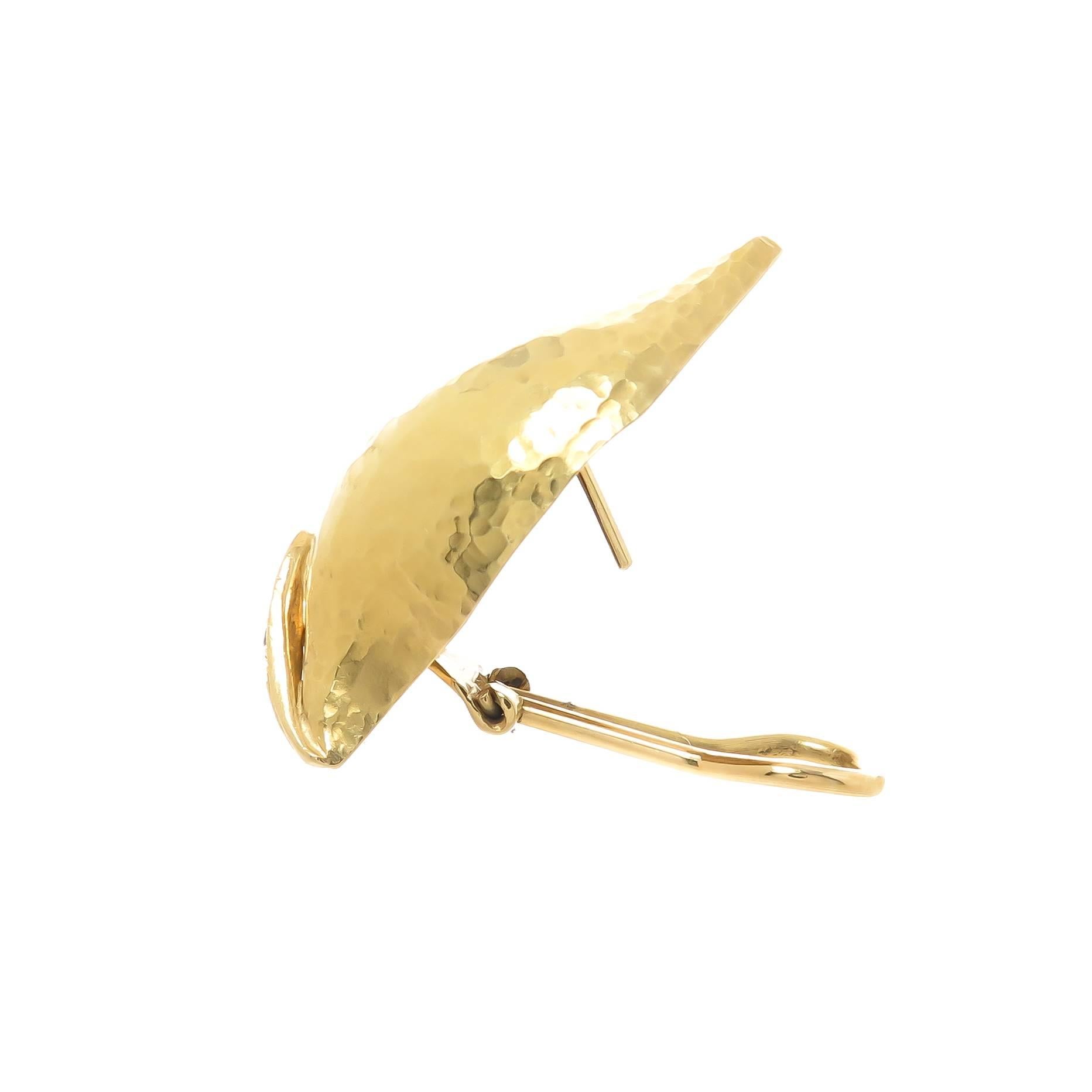 Circa 1990 Paloma Picasso for Tiffany & Company 18K yellow Gold Hand Hammered leaf Earrings, measuring 1 1/2 inch in length and 1/2 inch wide. Set with Round Brilliant cut Diamonds totaling .25 Carat. Having omega clip backs to which a post can be