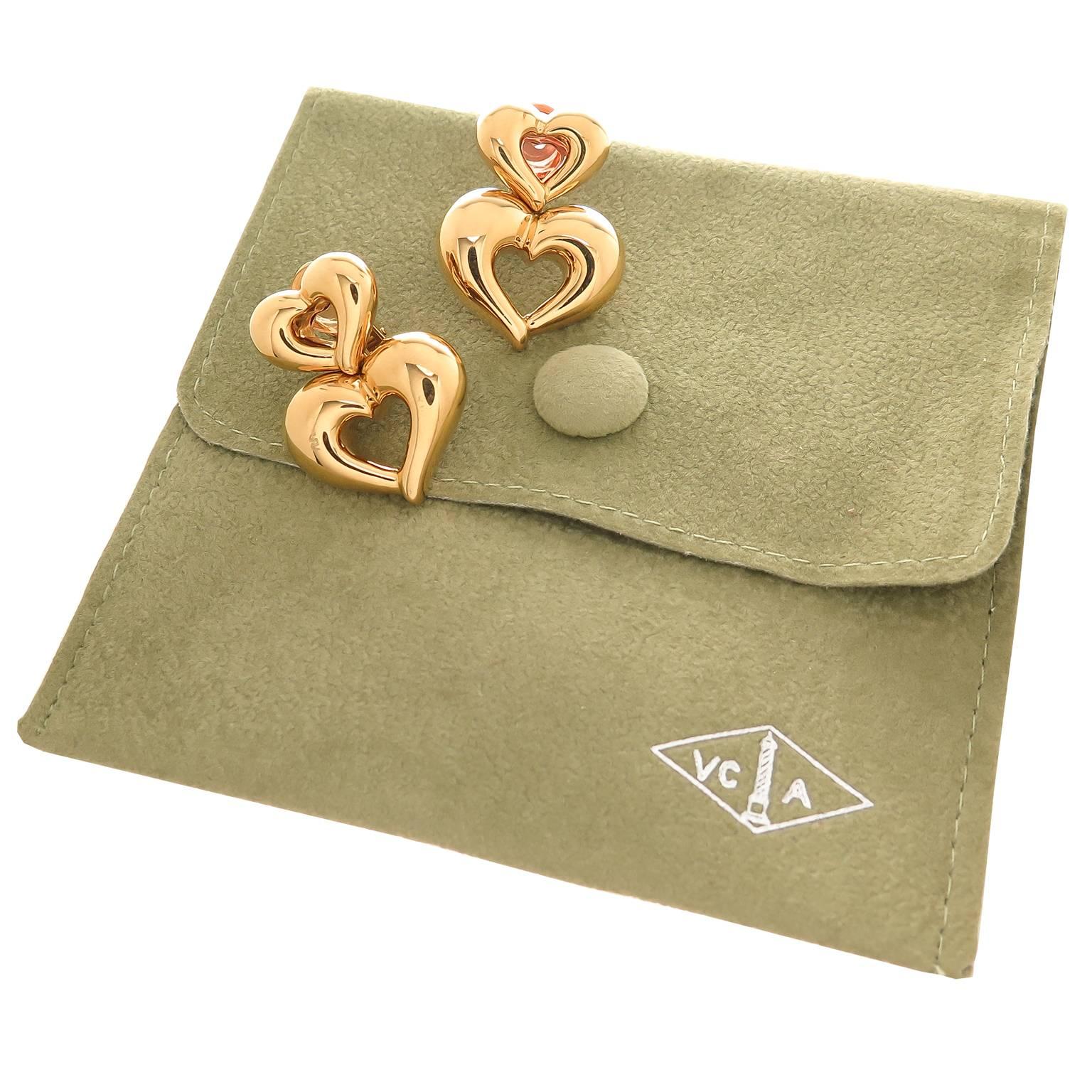 Circa 2005 Van Cleef and Arpels 18K yellow Gold Double Heart Earrings, measuring 1 1/8 inch in length and 7/8 inch wide. Having Clip backs to which a post can be easily added if desired. Come in Original VCA suede pouch.