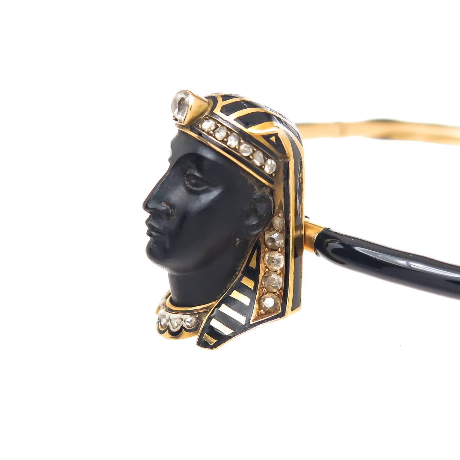 Circa 1910 Tiffany & Company 14K yellow Gold Egyptian revival Bangle Bracelet. Having Black Enamel and a Carved Black Stone Face and a Head Dress of Black enamel and further decorated with Rose cut and Mine cut Diamonds. The head portion measures 1