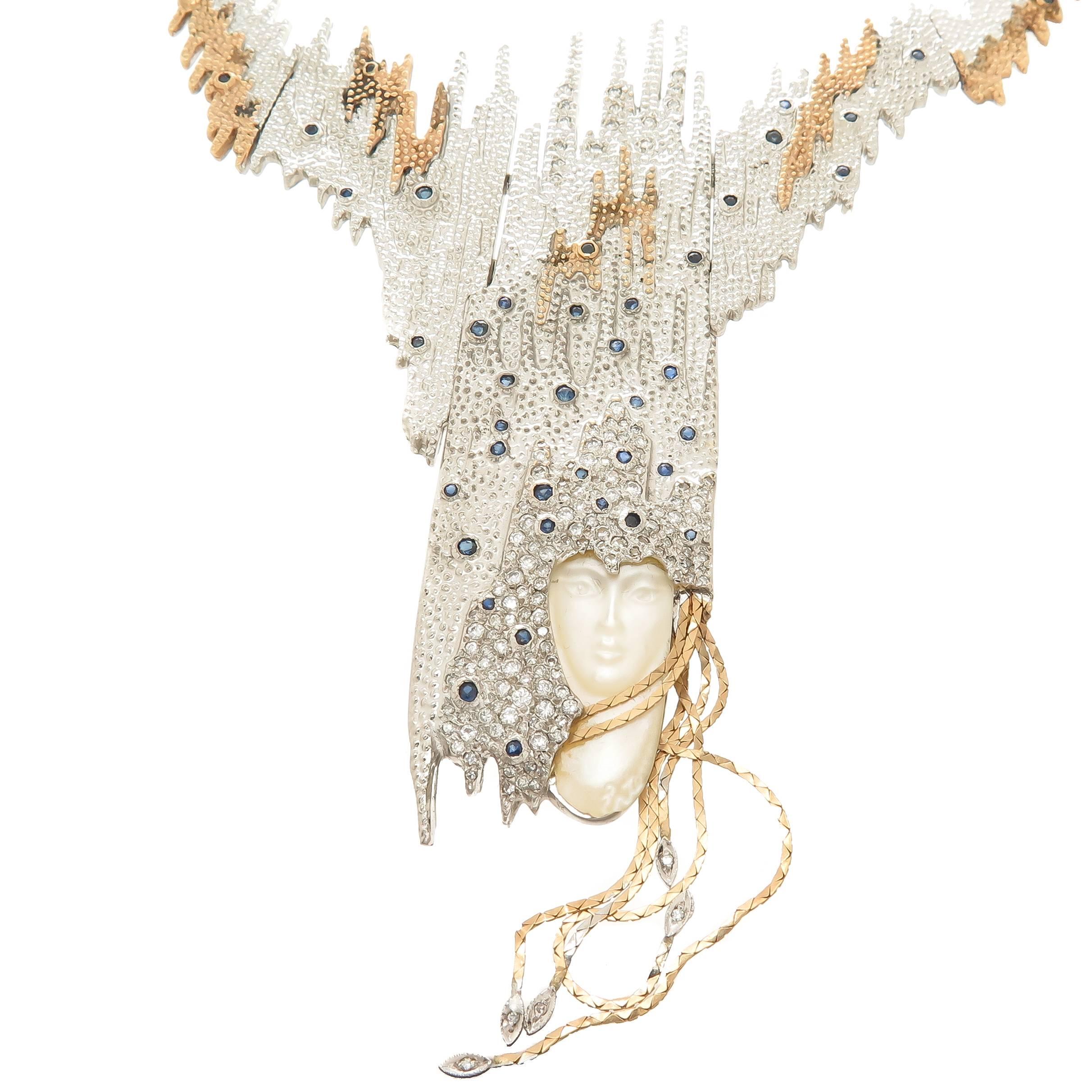 circa 1984 Sophistication Necklace by Erte, 14K Yellow Gold and Sterling Silver, Finely textured and having Granulation work throughout, set with Numerous Diamonds, Sapphires and a Carved Face of Mother Of Pearl. This Piece converts into a large