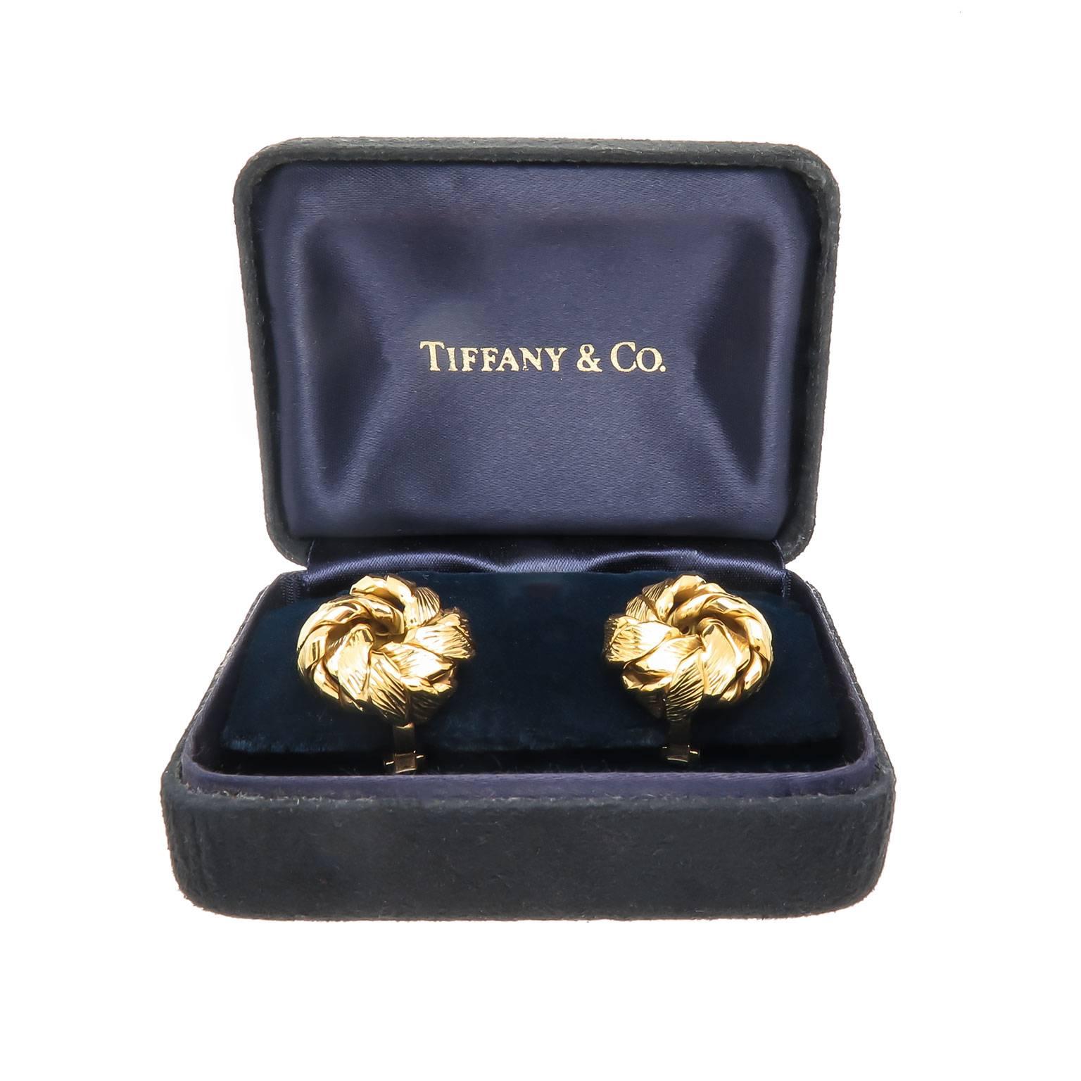 Circa 1990s Tiffany & Company 18K Yellow Gold Earrings, measuring 3/4 inch in diameter and just under 1/2 inch thick. Good solid construction with a textured finish and having good weight of 16.6 grams. Omega Clip backs with a post. Excellent near