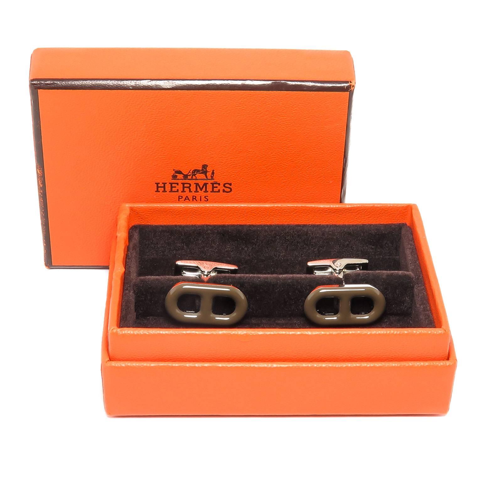 Circa 2005 Hermes Cufflinks, High Polished Metal and Chocolate Brown Enamel. These are new old Stock, never worn and in the original Hermes Gift Box. Measuring 3/4 inch in length across the top.