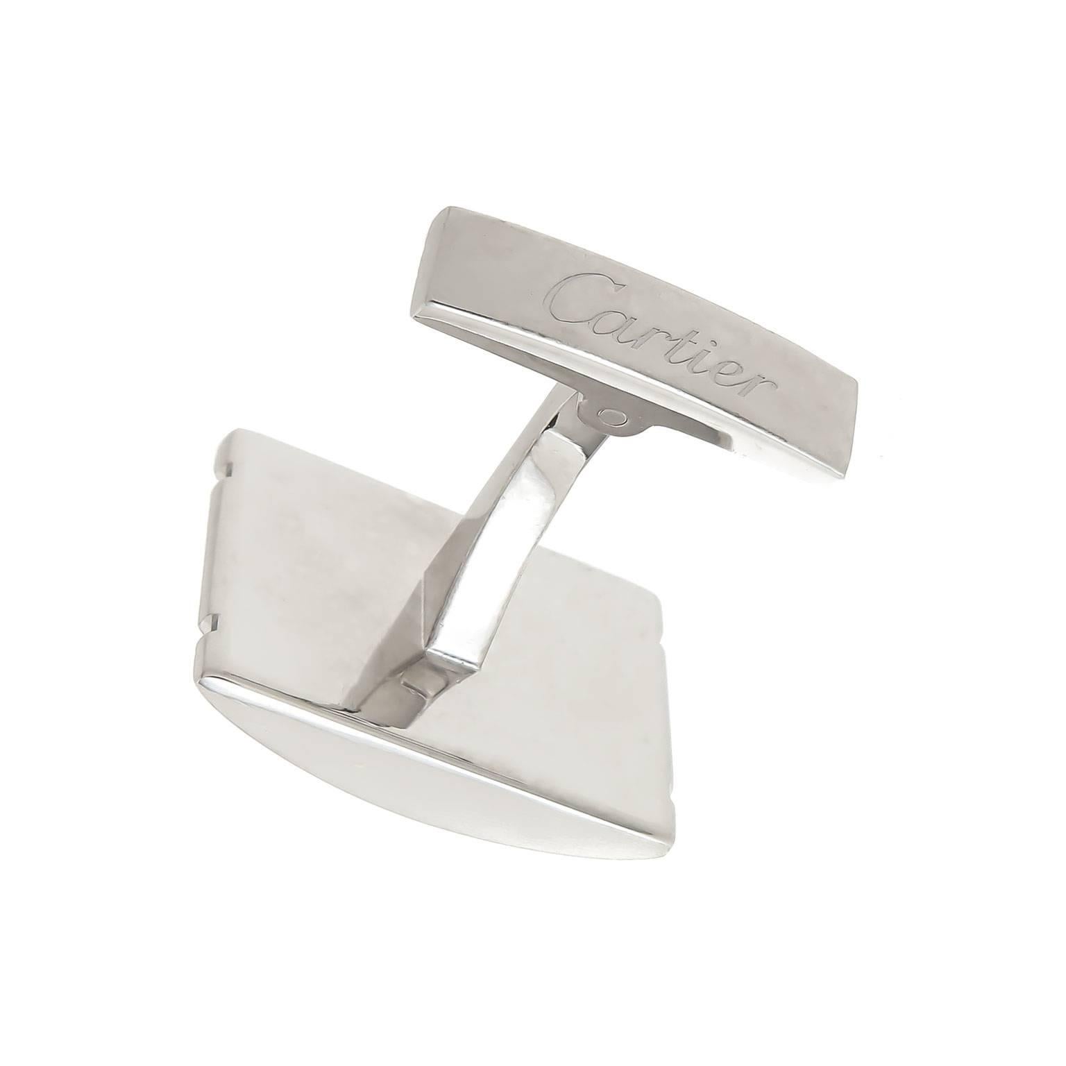 Circa 1990 Cartier Santos Collection  Stainless Steel cufflinks, Measuring 3/4 X 5/8 inch and having a center light Brushed finish with Gold Screws. Comes in a Cartier Suede Pouch.