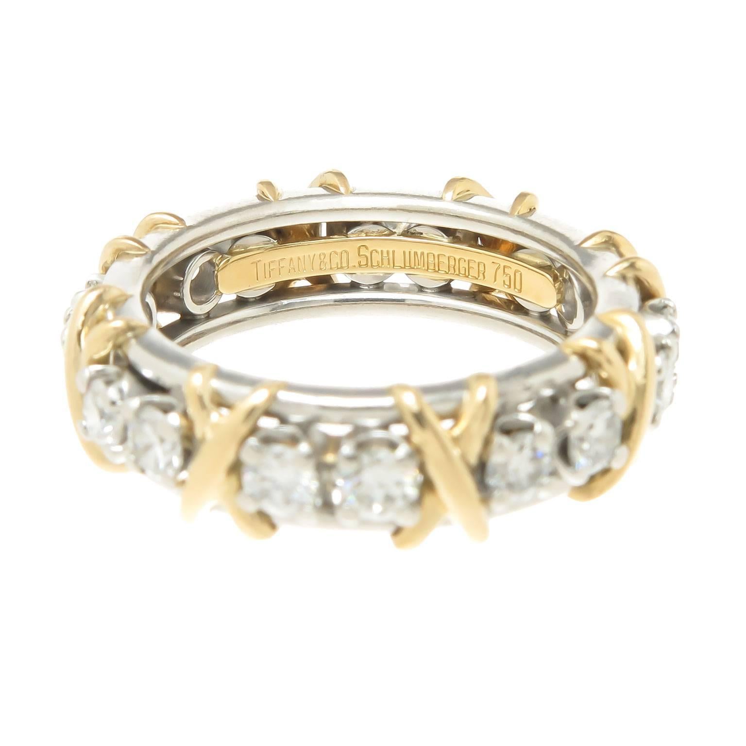 Circa 2005 Jean Schlumberger for Tiffany & Company Platinum and 18K yellow Gold X Band Ring, measuring 6 MM wide and set with 16 Round Brilliant cut Diamonds totaling 1.16 carat. Finger size = 6 1/2