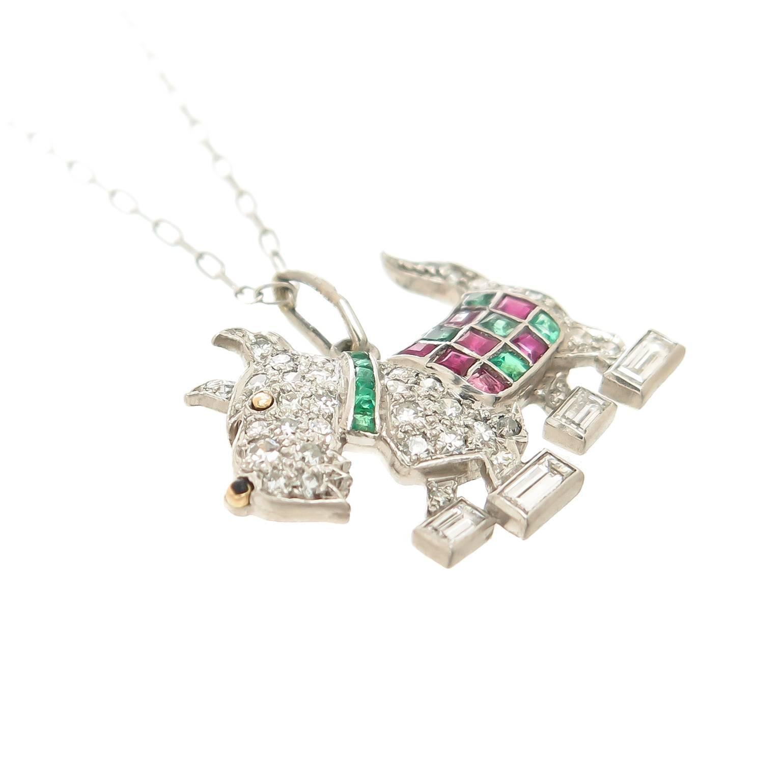 Circa 1930s Platinum, Scottish or west Highland Terrier pendant, set with Round and Fancy cut Diamonds and square cut Emeralds and Rubies. measuring 3/4 inch in length and 5/8 inch in height. Suspended from an 18 inch Platinum chain.