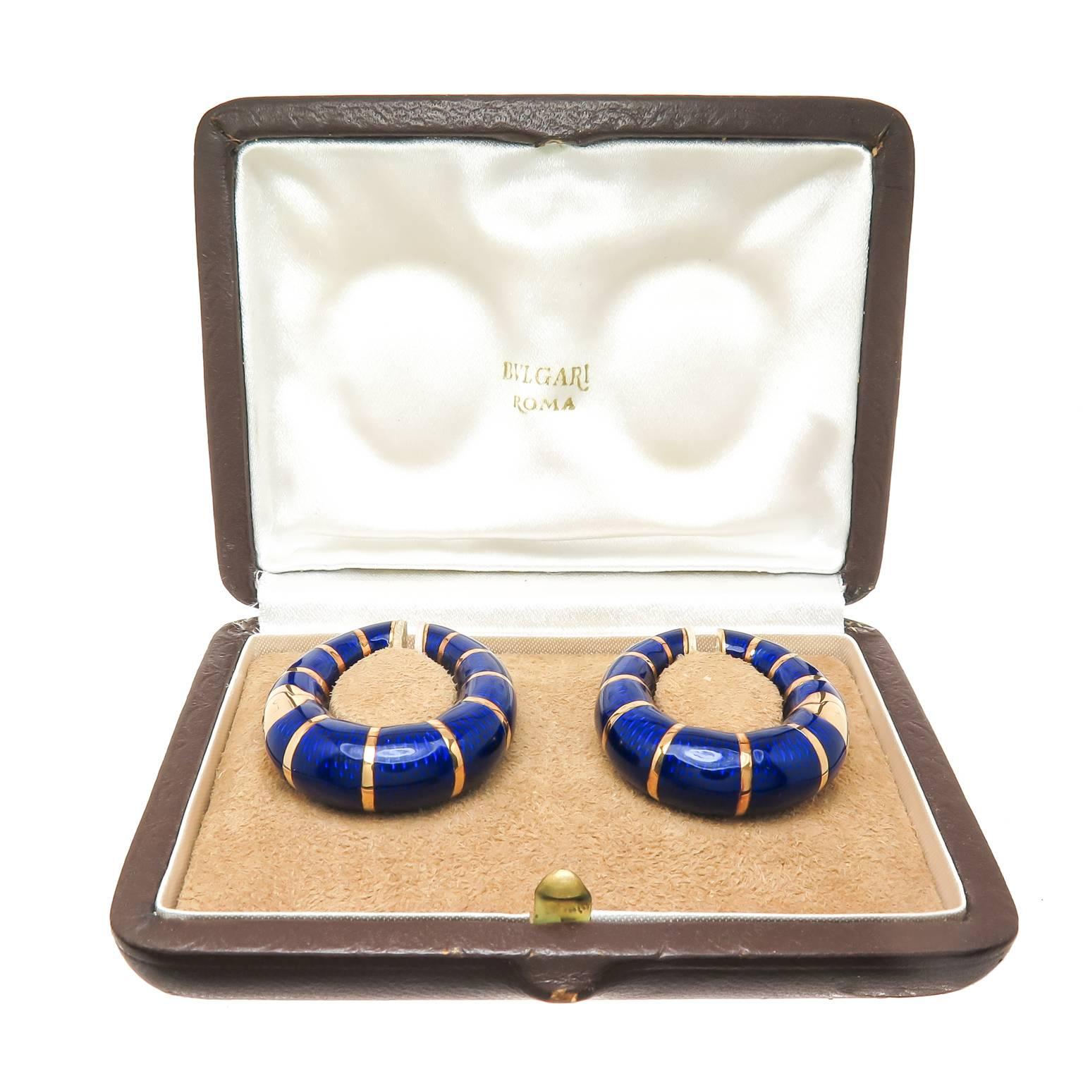 Circa 1970s Bulgari 18K yellow Gold and Cobalt Blue Guilloche Enamel, measuring 1 1/2 inch in length, 1 3/16 inch wide and 3/8 inch thick at the bottom. Having a good weight of 36.4 grams for the pair.These Earrings come in the original Bulgari