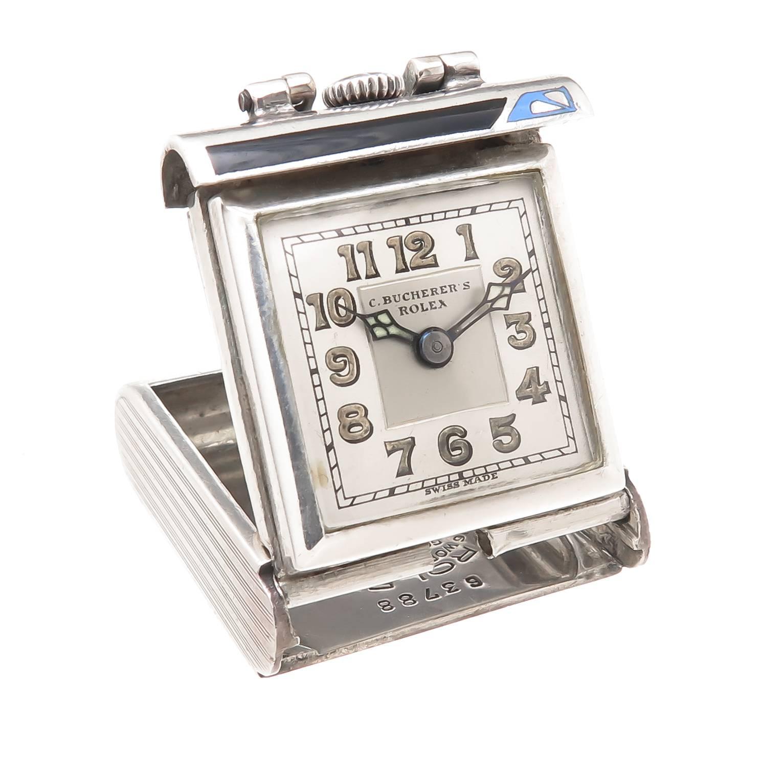 Circa 1940 Rolex Travel Watch, Sterling Silver case measuring 1 1/8 X 1 inch with fold open mechanism so the watch can be placed for viewing on a table etc. 15 Jewel Rolex Prima, Manual wind movement.  Blue and Black Art Deco Enamel. Original 2 tone