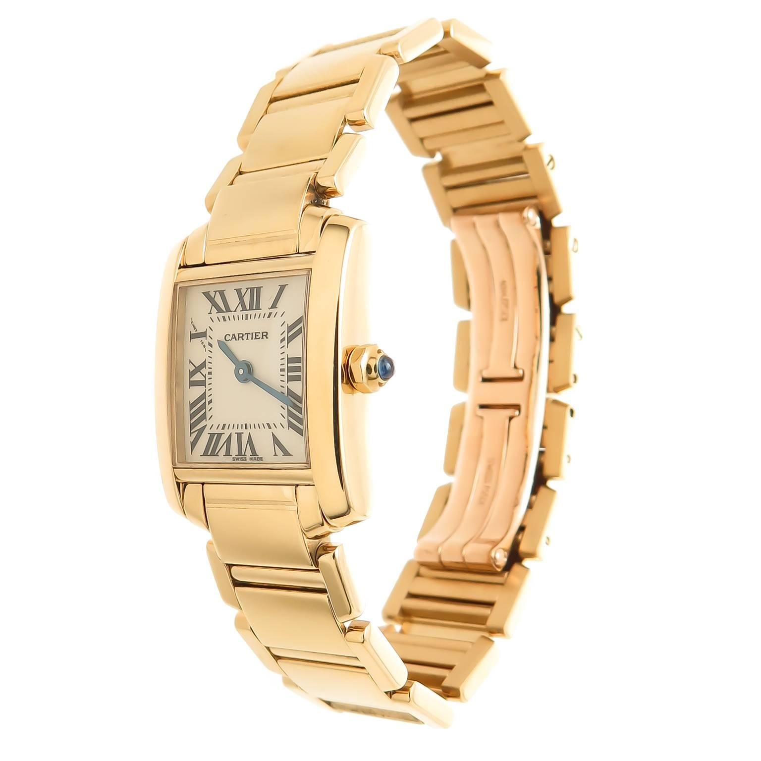 Circa 2012 Cartier 18K yellow Gold Tank Francaise ladies Wrist watch, 25 X 20 MM water Resistant case, Quartz Movement, White Dial with Black Roman numerals, Scratch resistant crystal and a Blue Spinel crown. 5/8 inch wide bracelet with deployment