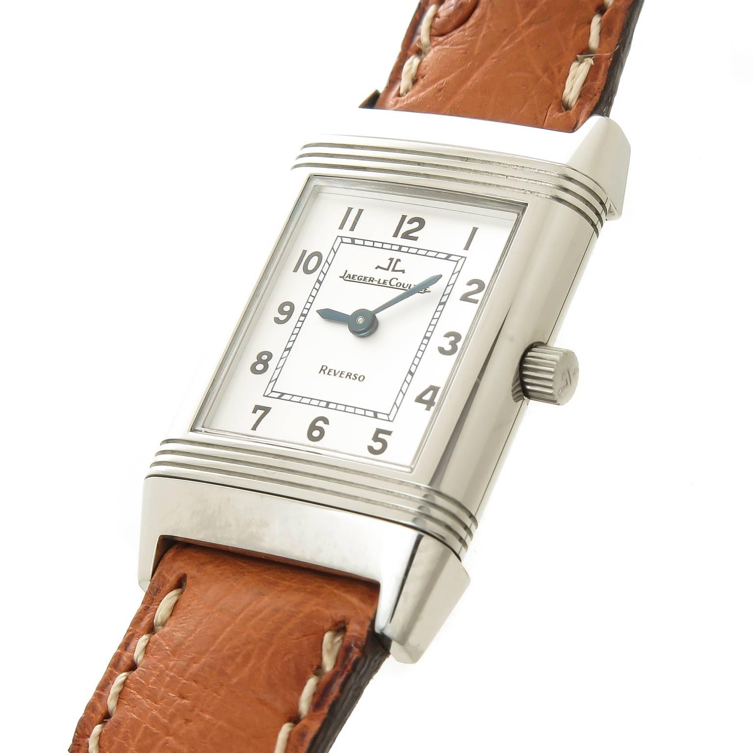 Circa 2010 LeCoultre ladies Reverso Wrist watch, 33 X  20 MM Stainless Steel Case, Quartz movement, silvered Dial with Black Numbers . Original Tan padded strap with LeCoultre Steel Tang buckle. Total watch length 8 inches. recently serviced and