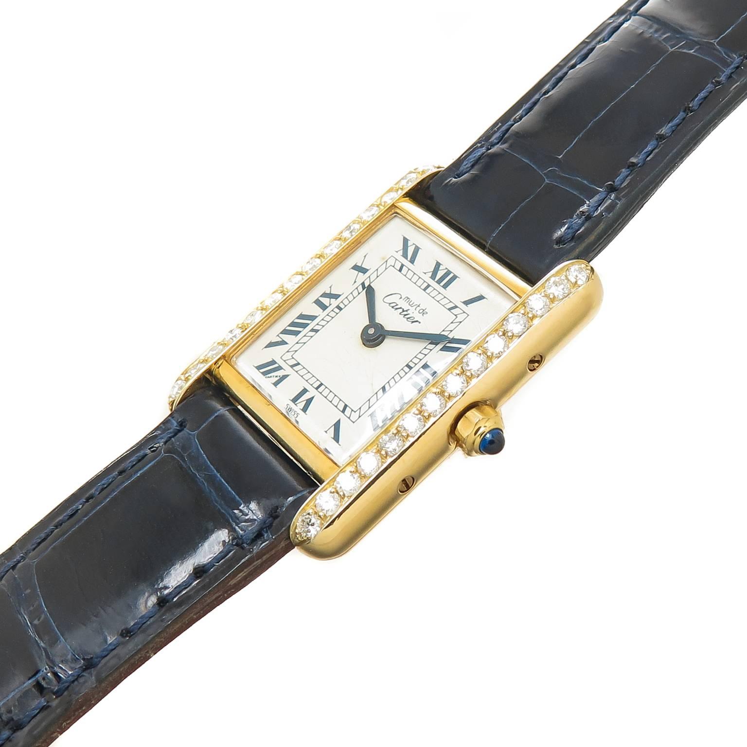 Circa 2000 Cartier, Must de Cartier Classic Tank Watch 28 X 20 MM mid size Vermeil  Gold Plate on Sterling Silver water resistant case. Set with Round Brilliant cut Diamonds totaling .58 Carat. Quartz Movement, White Dial with Blue Roman Numerals,
