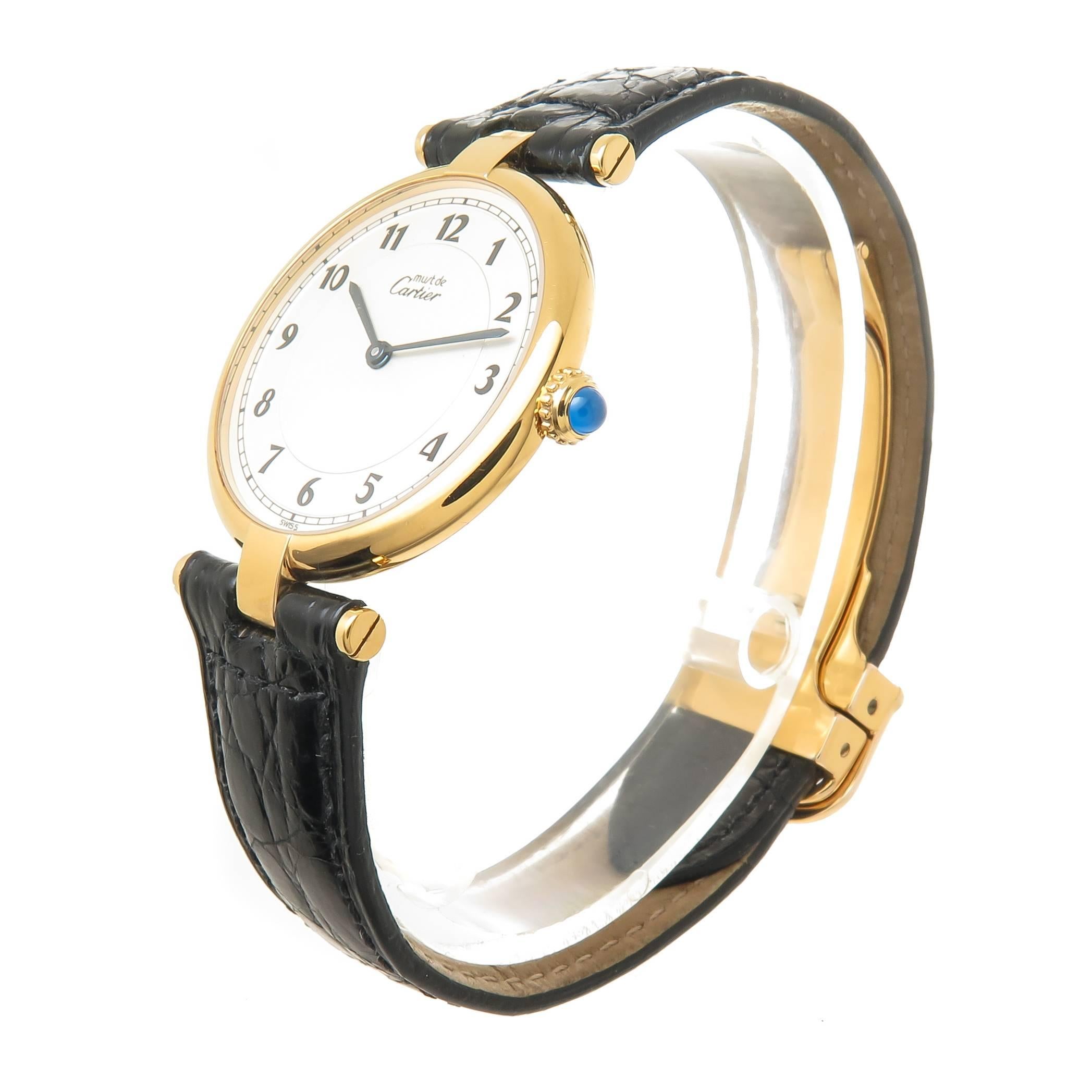 Circa 2000 Cartier Must De Cartier Vendome Wrist Watch, 30 MM Vermeil, Gold Plate Sterling Silver water resistant case. Quartz Movement, White dial with Black numerals,Sapphire Crown. Black Padded adjustable Cartier Strap with Gold Plate Cartier