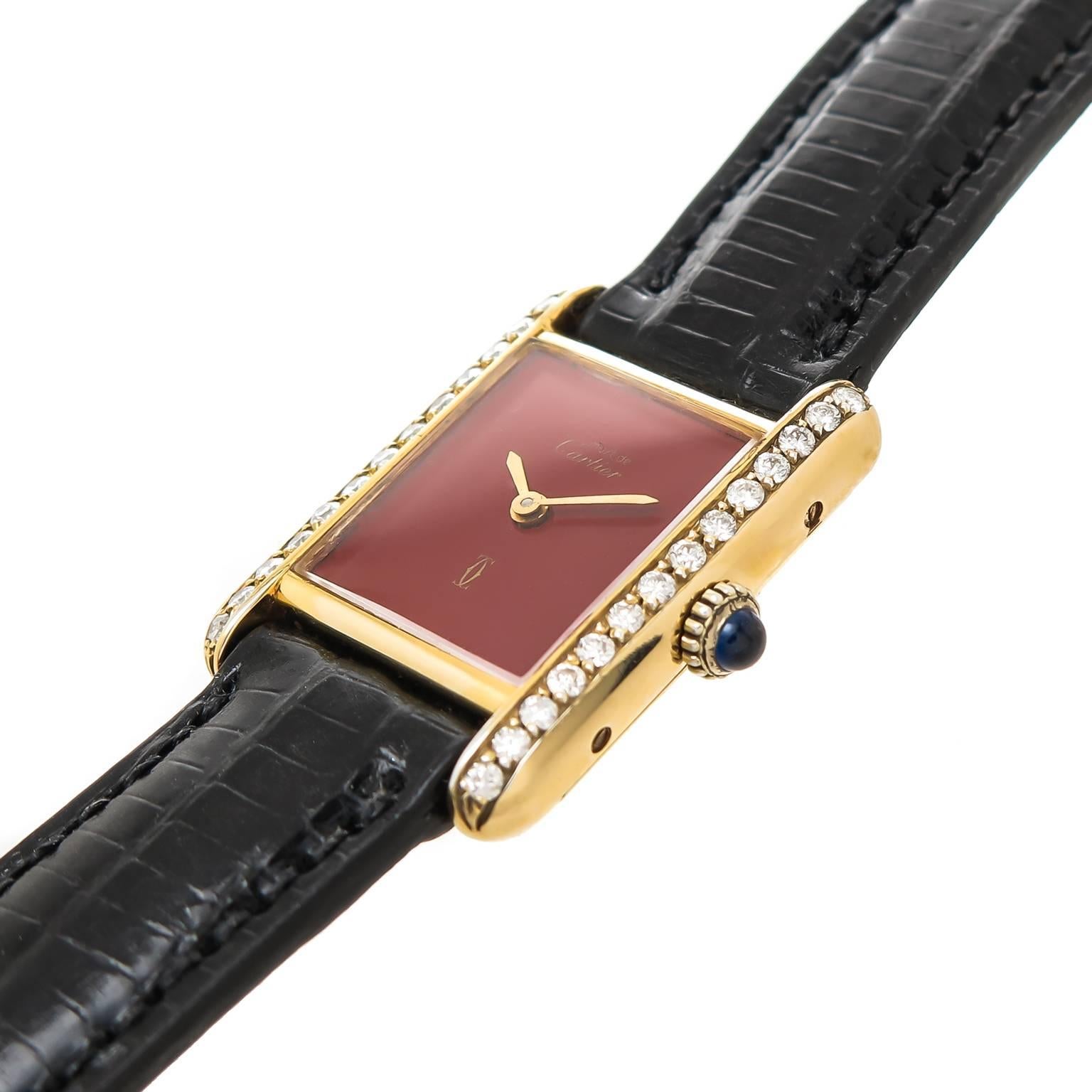 Circa 2000 Cartier, Must De Cartier Classic Ladies Tank Wrist Watch, 28 X 20 MM Vermeil ( Gold Plate Sterling Silver ) water resistant case with Round Brilliant cut Diamond set Bezel totaling .75 Carat. Quartz Movement, Red Dial with Gold Hands. New