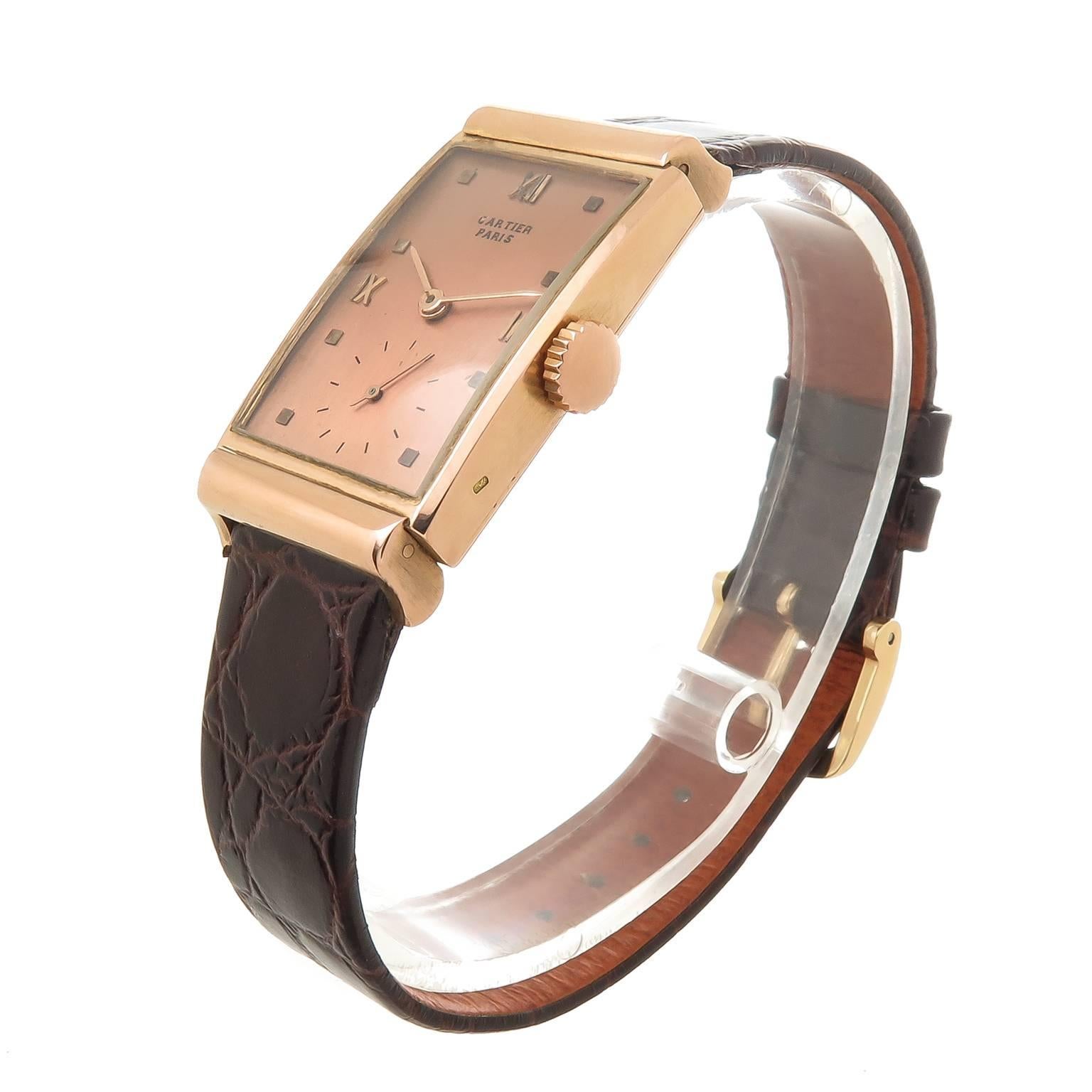 Circa 1940s Patek Philippe Gents wrist watch retailed by Cartier.  18K Rose Gold 40 X 20 MM 2 piece case with hooded lugs. 18 Jewel Manual wind mechanical Caliber PXP movement. Rose Dial with raised Rose gold markers and Rose gold hands. New Hirsh