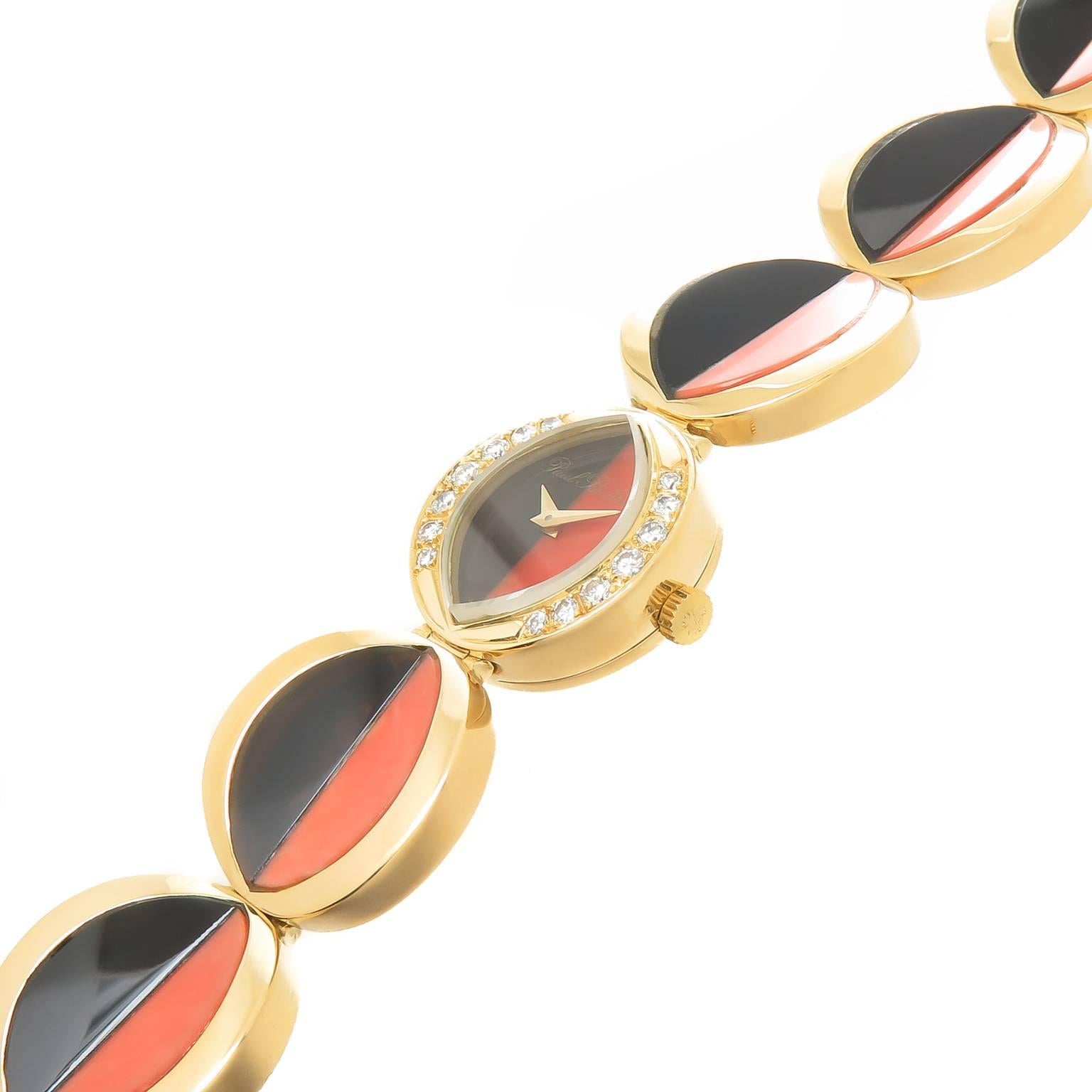 Circa 1980s 18K Yellow Gold Ladies flexible Bracelet Wrist Watch, measuring 6 3/4 inch in length and 3/4 inch wide. Each linked section is set with a half moon shape Coral and Onyx. The watch face is also half moon Coral and Onyx and Round Brilliant