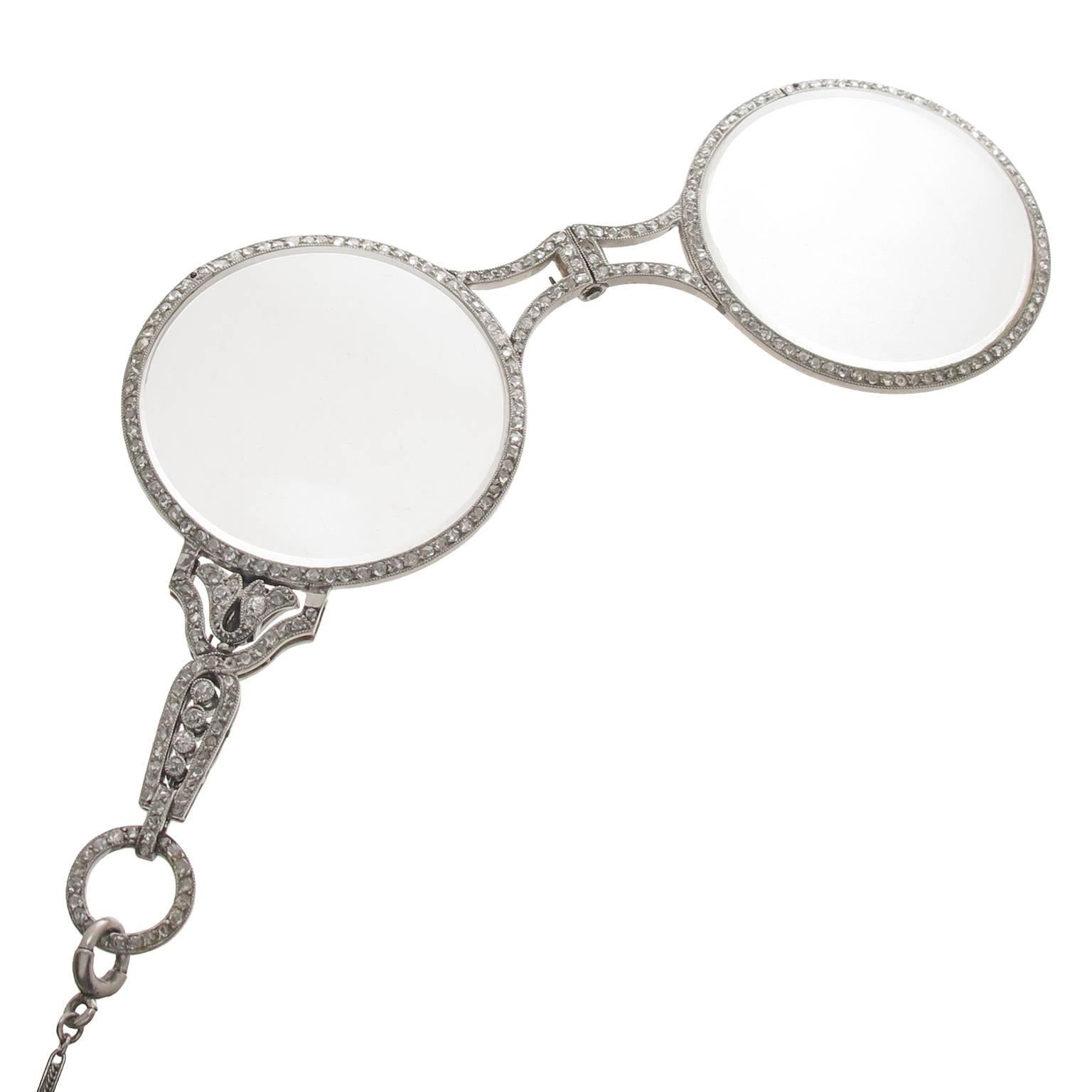 Circa 1910 Cartier Paris Platinum and Diamond set Lorgnette, measuring 3 1/4 inch in length and 1 1/2 inch in diameter. set on both sides with Rose cut Diamonds totaling approximately 3 Carats. Having the original Magnifying, reading lenses. The